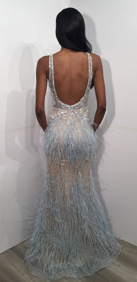 Jovani 03023 is a 2021 Prom Dress, Pageant Gown, Wedding Dress & Formal Evening wear. This Sheer embellished bodice features a plunging v neckline with beading & crystal accents cascading through a feather embellished skirt. Very stunning and unique wedding dress!   Available Colors: Off White, Blush, Black  Available Sizes: 00-24