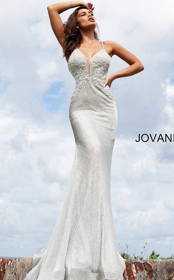 Jovani 03167 is a 2021 Prom Dress, Pageant Gown & Formal Evening Wear.  Details: Silver lace dress, fully lined, form fitting silhouette, floor length, embellished Spaghetti strap bodice, plunging neckline with mesh insert for support, open back with embellished criss cross straps. Available Sizes: 00,0,2,4,6,8,10,12,14,16,18,20,22,24 Available Colors: Silver
