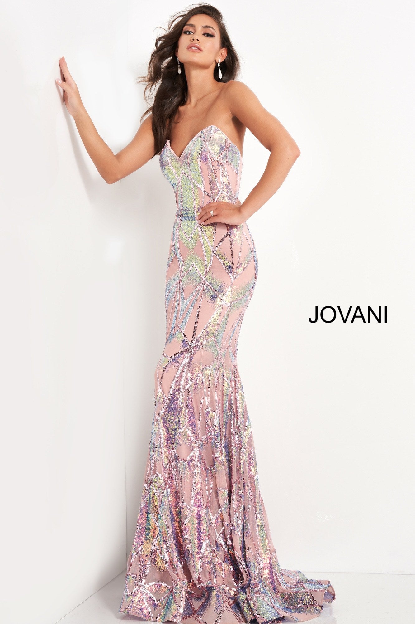 Jovani 05100 is a long Fitted formal evening gown. Featuring a strapless peak - deep sweetheart neckline. This stunning Pageant & Prom Gown is Fully Embellished with Glitter & Sequins to Create A Glamorous Geometric dimensional design. Mermaid silhouette with a lush trumpet skirt & sweeping train.  Available Sizes: 00,0,2,4,6,8,10,12,14,16,18,20,22,24  Available Colors: black/multi, light-blue, navy, pink