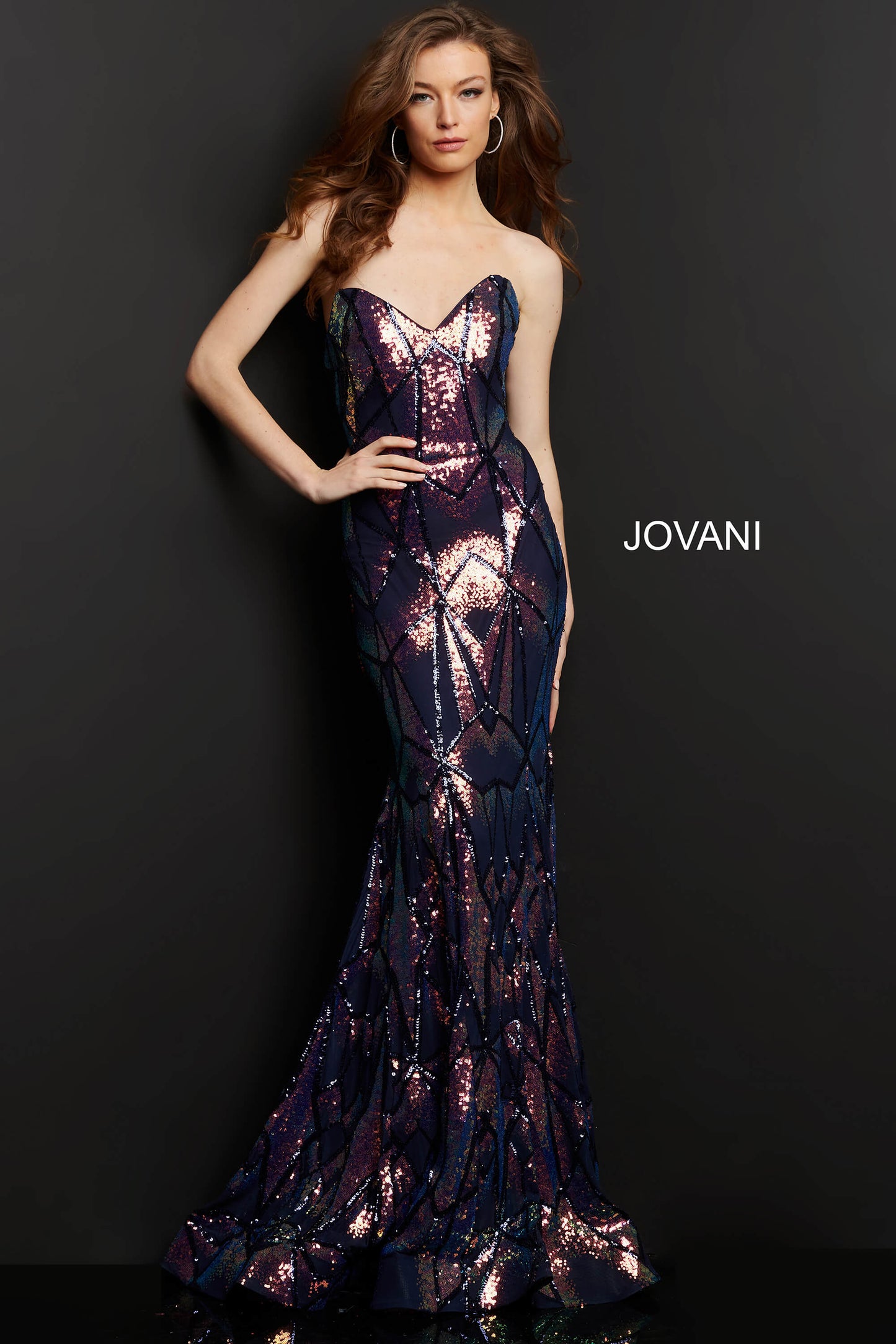 Jovani 05100 is a long Fitted formal evening gown. Featuring a strapless peak - deep sweetheart neckline. This stunning Pageant & Prom Gown is Fully Embellished with Glitter & Sequins to Create A Glamorous Geometric dimensional design. Mermaid silhouette with a lush trumpet skirt & sweeping train.   Available Sizes: 00,0,2,4,6,8,10,12,14,16,18,20,22,24  Available Colors: black/multi, light-blue, navy, pink