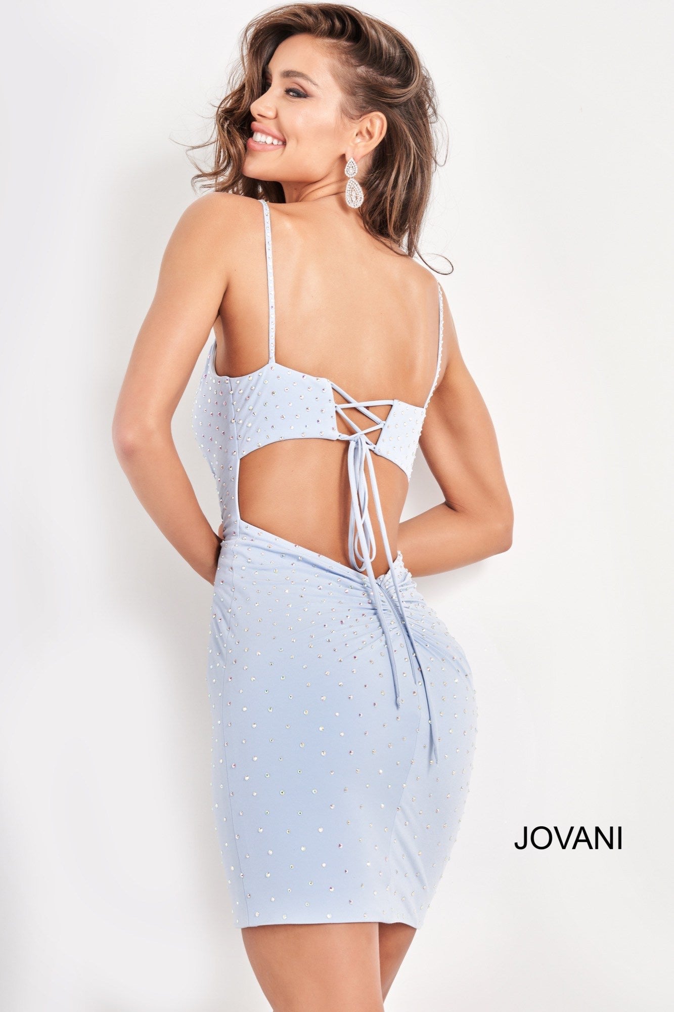Jovani 05513 is a short fitted Crystal Rhinestone embellished formal cocktail dress. V Neckline with embellished spaghetti straps. cut out back with a corset lace up tie closure. Ruched hip area accentuates curves. Great formal evening gown.  Available Sizes: 00,0,2,4,6,8,10,12,14,16,18,20,22,24  Available Colors: Light Blue, Black