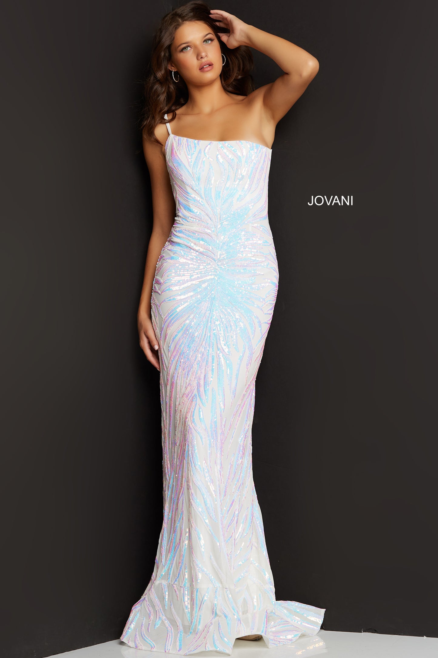 Jovani 05664 is a long fitted formal evening gown. This one shoulder Prom Dress has a Fit & Flare silhouette. Featuring Iridescent Embellished Sequin Asymmetrical  Starburst patterns that accentuate any figure! Lush sweeping train is perfect for Pageant Presence on stage!   Closure: Invisible Back Zipper with Hook and Eye Closure. Details: Sequin embellished prom gown, form-fitting silhouette, floor length, one-shoulder sleeveless bodice.