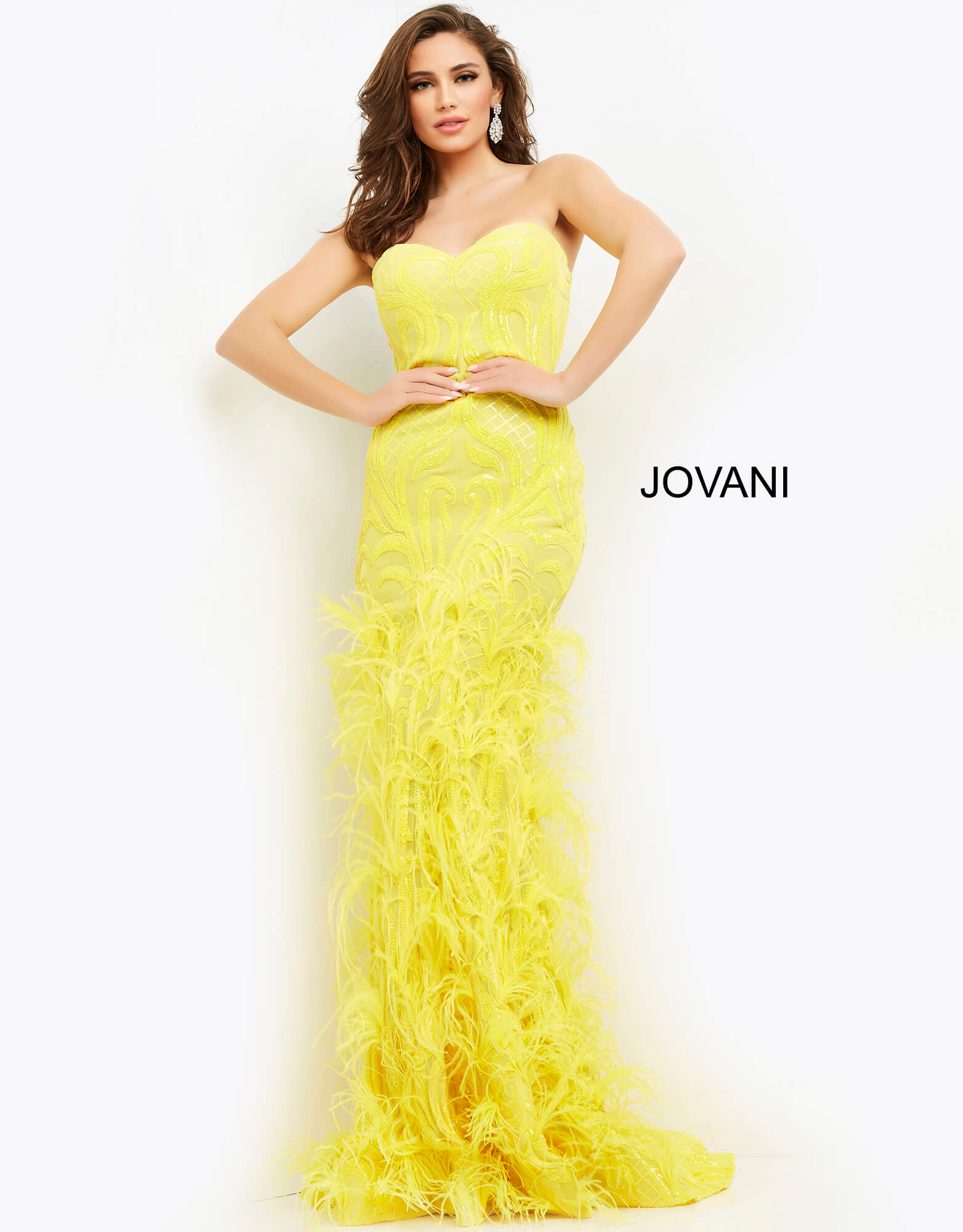 Jovani 05667 This is a long prom dress with feather details on the bottom of the skirt.  This pageant gown has a sweetheart neckline and is strapless.  Perfect evening gown for a Red Carpet event.  Colors:  Yellow, White  Sizes  00-24