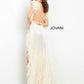 Jovani 06164 This extravagant Prom, Pageant and Evening Gown has a Plunging neckline with feather details on the straps and surrounding the high thigh side slit.  The long prom dress has sequins throughout and has a sexy open back.   Colors  Cream, Lilac  Sizes  00-24