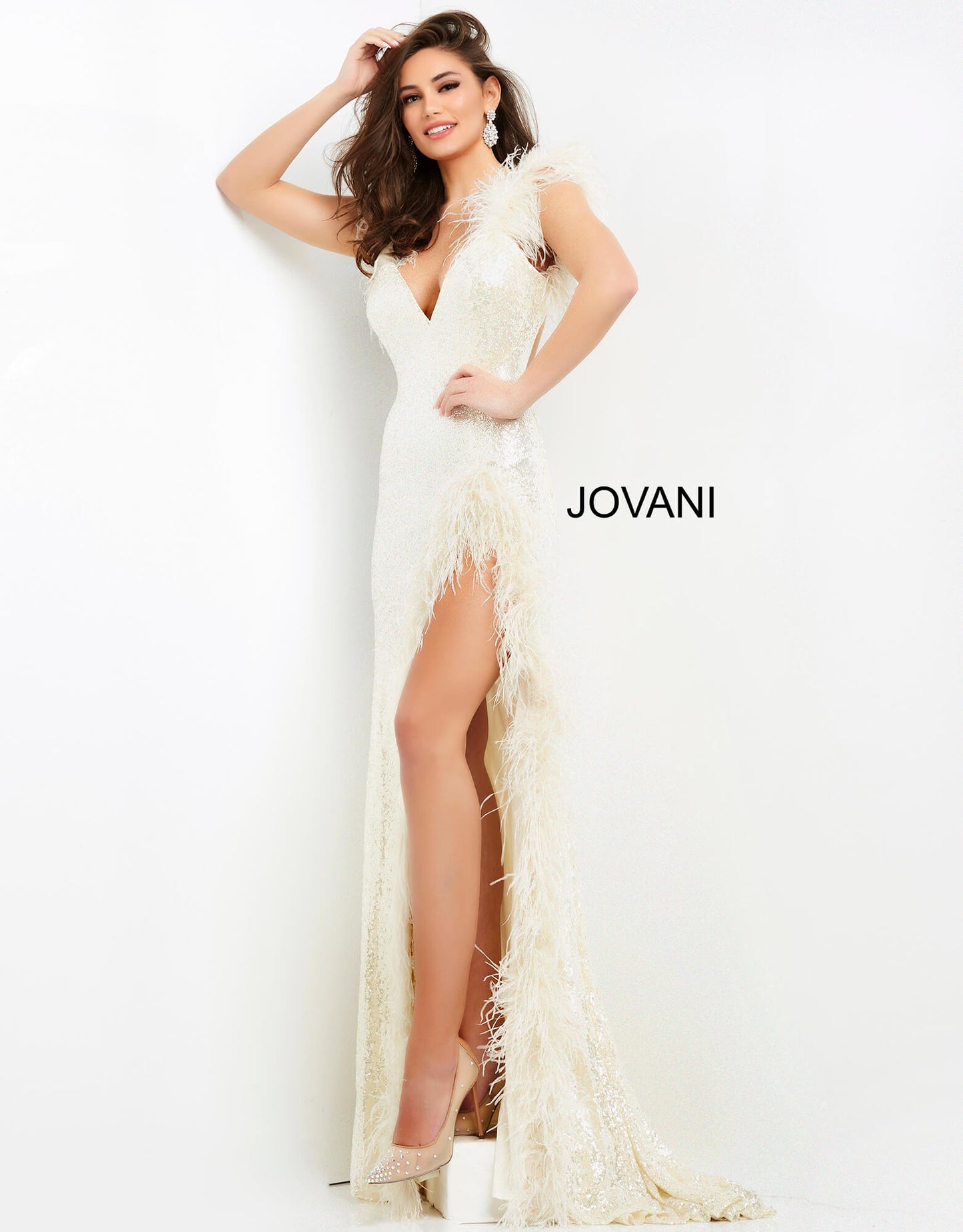 Jovani 06164 This extravagant Prom, Pageant and Evening Gown has a Plunging neckline with feather details on the straps and surrounding the high thigh side slit.  The long prom dress has sequins throughout and has a sexy open back.   Colors  Cream, Lilac  Sizes  00-24