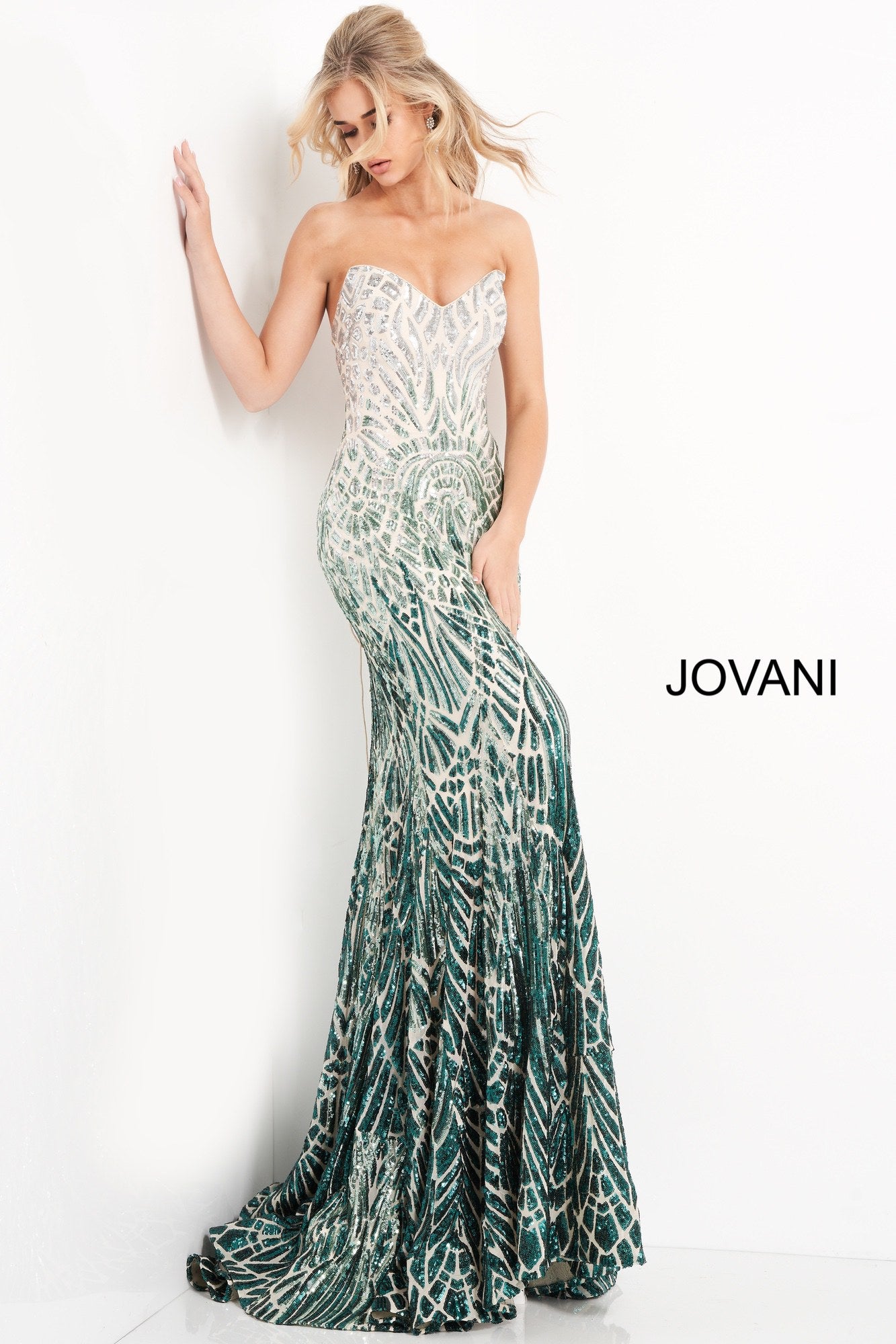 Jovani 06459 is a long fitted Formal Evening Gown. This Strapless Prom Dress Features a Backless open back with a corset style lace up closure. Peak point strapless neckline. Fully Embellished with Sequins in a cascading geometric pattern in an Ombre Design. Lush trumpet skirt with a sweeping train. Perfect for pageants! Available Sizes: 00,0,2,4,6,8,10,12,14,16,18,20,22,24  Available Colors: Silver/Cafe, Silver/Green