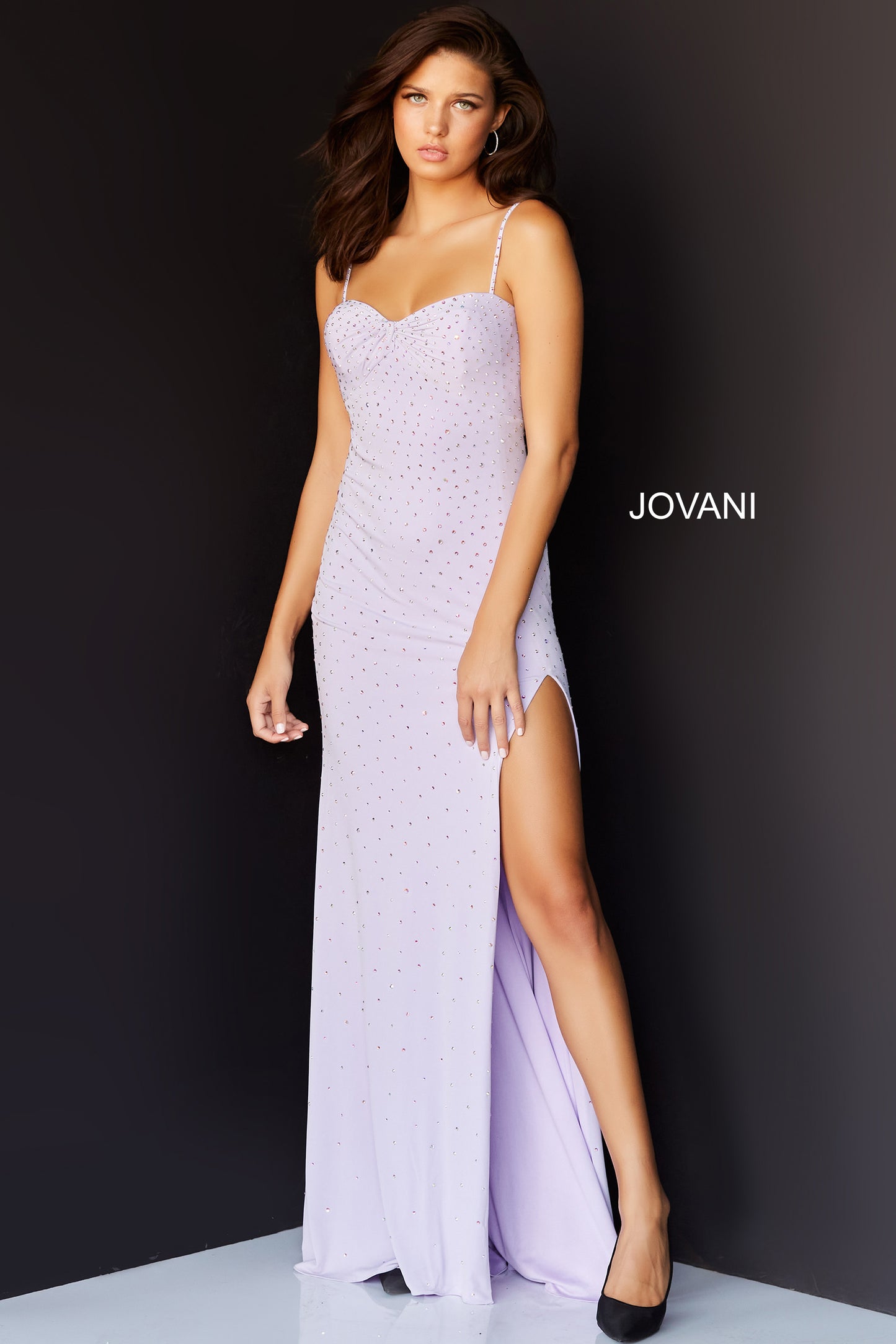 Jovani 06502 Floor length form fitting lilac beaded jersey Jovani prom dress 06502 with high slit features ruched twisted bust, spaghetti strap sweetheart neckline.
