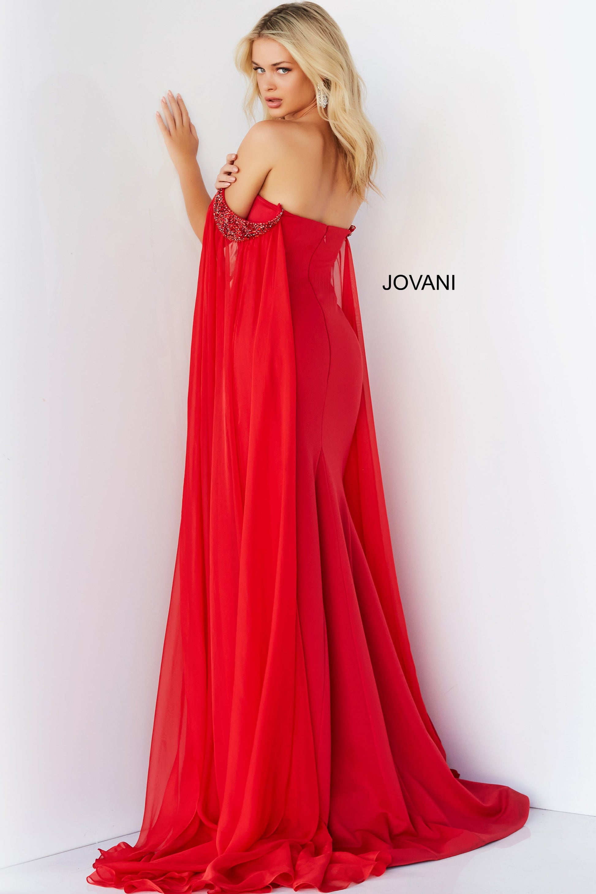 Jovani 07652 Prom Dress Cape Sleeves Pageant Gown.  This is a strapless prom dress with flattering fitted silhouette with an off-the-shoulder sweetheart neckline. It has  beaded chiffon around the arms with long sheer sweeping chiffon Cape Sleeves.  Excellent choice for Pageants.