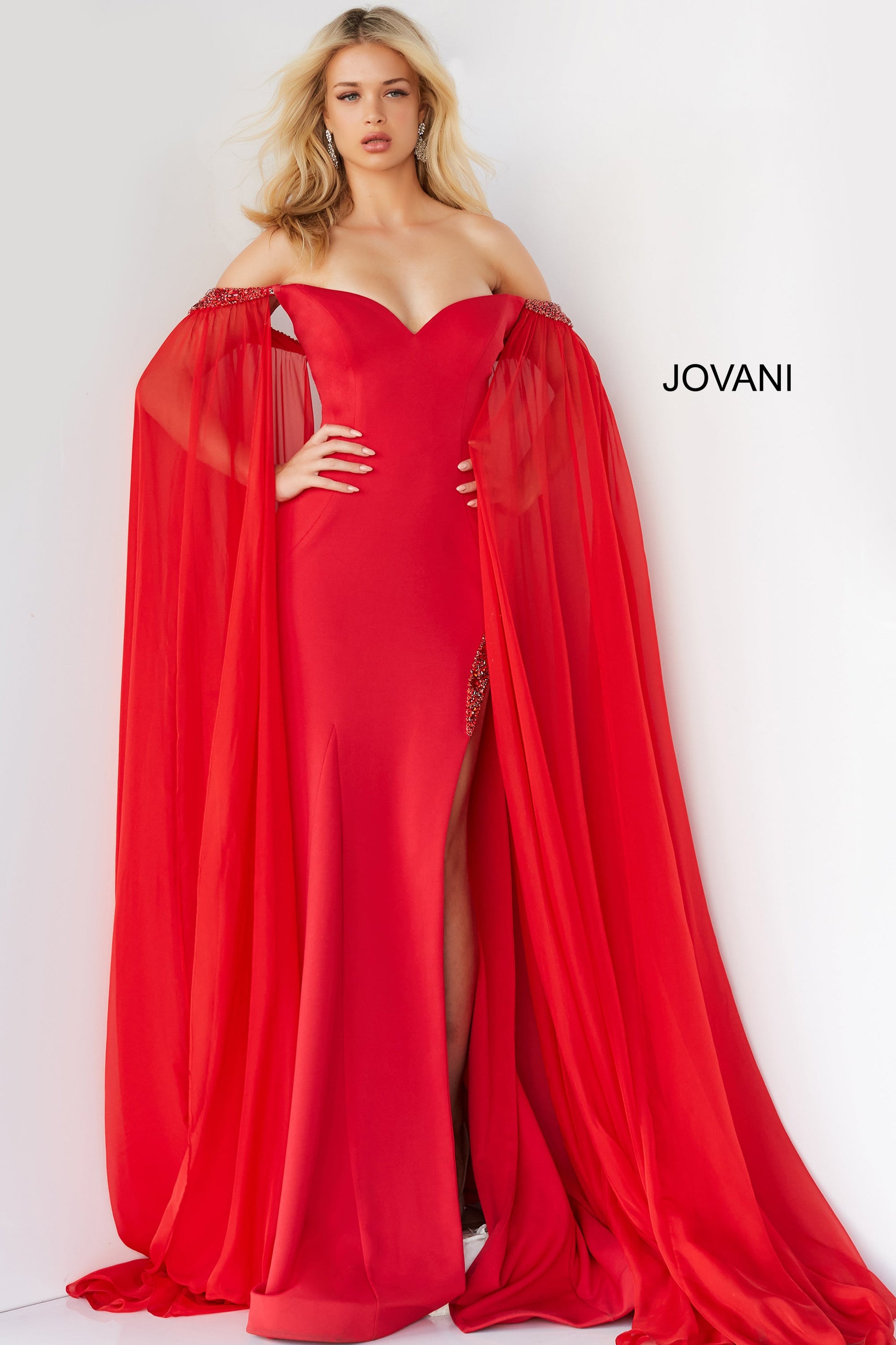 Jovani 07652 Prom Dress Cape Sleeves Pageant Gown.  This is a strapless prom dress with flattering fitted silhouette with an off-the-shoulder sweetheart neckline. It has  beaded chiffon around the arms with long sheer sweeping chiffon Cape Sleeves.  Excellent choice for Pageants.