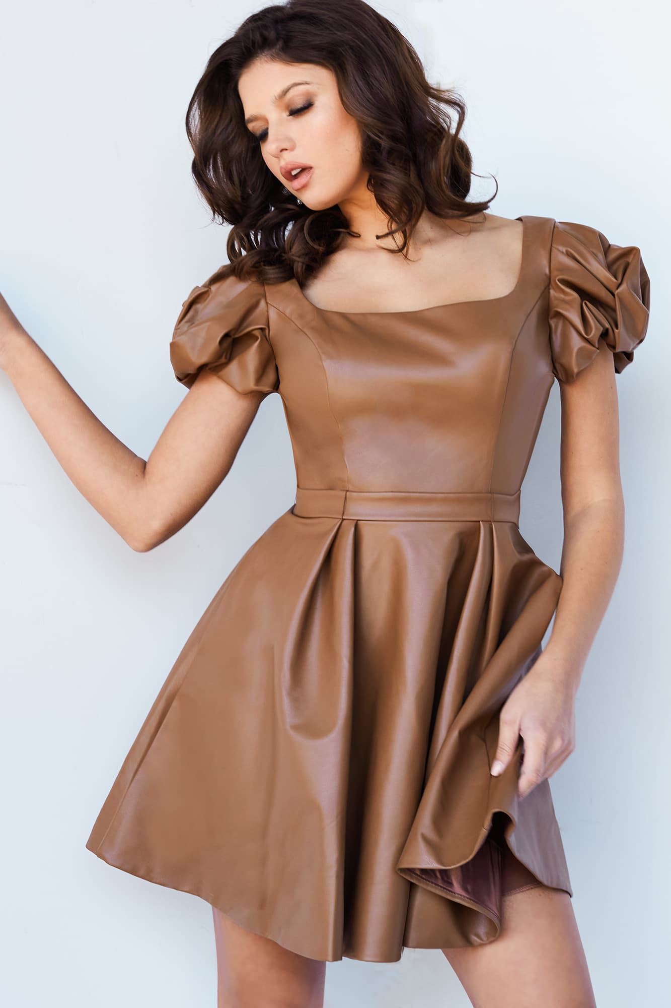 Jovani 09690 Short Fit & Flare Pleather Cutout Back Puff Sleeve Formal Cocktail Dress Interview This Jovani 09690 caramel cocktail dress features an A-line silhouette in premium pleather, with a square neckline, puff sleeves, and a lower back cutout.  Available Sizes: 00,0,2,4,6,8,10,12,14,16,18,20,22,24  Available Colors: Black, Caramel, Olive