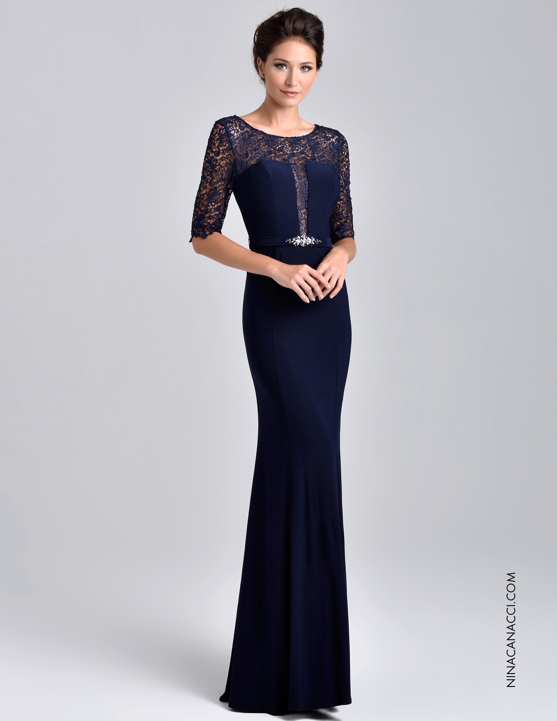 Nina Canacci M218 This stunning evening gown features a scoop neckline with three quarter length sleeves. Sheer lace wraps the top, glides down the center bodice and rounds the slim waist. Accenting the front side of the band are clustered beads that add sparkle and flair. The slim silhouette will showcase your best figure with the full length hem completes the impressive look. Available Sizes: 6, 8, 10  Available Colors: Taupe