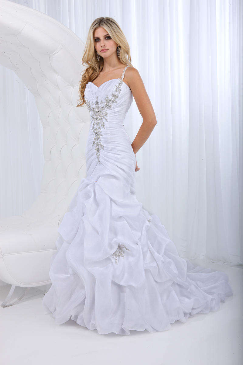 Impression Wedding Dress 10022. Organza satin sheath gown with a sweetheart neckline and beaded shoulder straps that extend down to a ruched bodice with floral accent, lace up back, cascading pick-up skirt highlighted by beaded embellishments and a chapel length train.