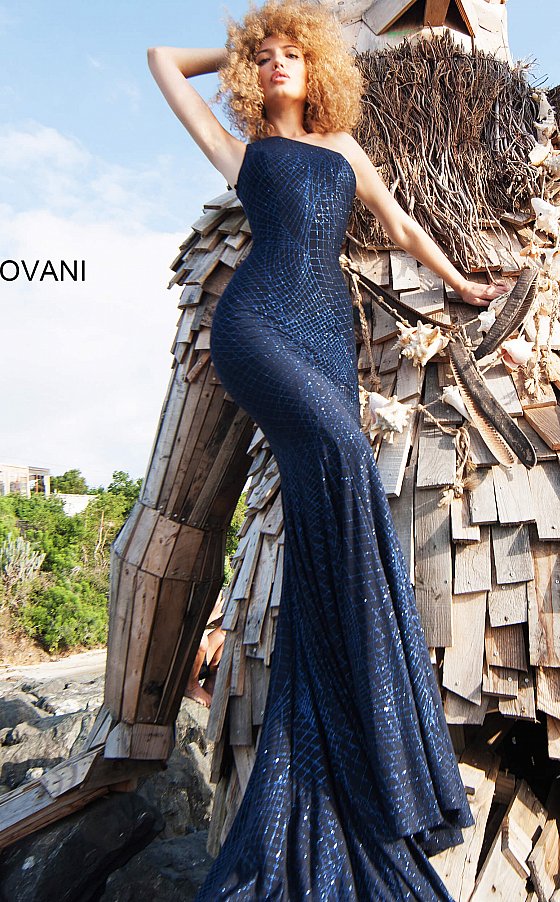 Jovani 1119 is a long fitted stretch jersey Prom, Pageant, Evening & Wedding Dress. Featuring a glitter embellished jersey. One shoulder neckline. Slighty Flared skirt. Stretch jersey dress embellished with glitter, form fitting silhouette with straight skirt, floor length, sleeveless bodice with one shoulder asymmetric neckline. Excellent Bridesmaid & Wedding Guest Dress!  Available Colors: magenta, navy, off white/gold