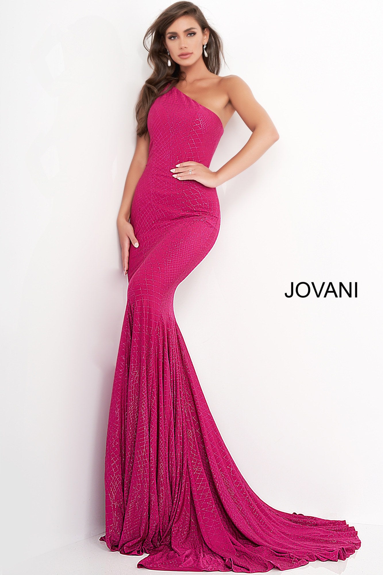 Jovani 1119 is a long fitted stretch jersey Prom, Pageant, Evening & Wedding Dress. Featuring a glitter embellished jersey. One shoulder neckline. Slighty Flared skirt. Stretch jersey dress embellished with glitter, form fitting silhouette with straight skirt, floor length, sleeveless bodice with one shoulder asymmetric neckline. Excellent Bridesmaid & Wedding Guest Dress!  Available Colors: magenta, navy, off white/gold