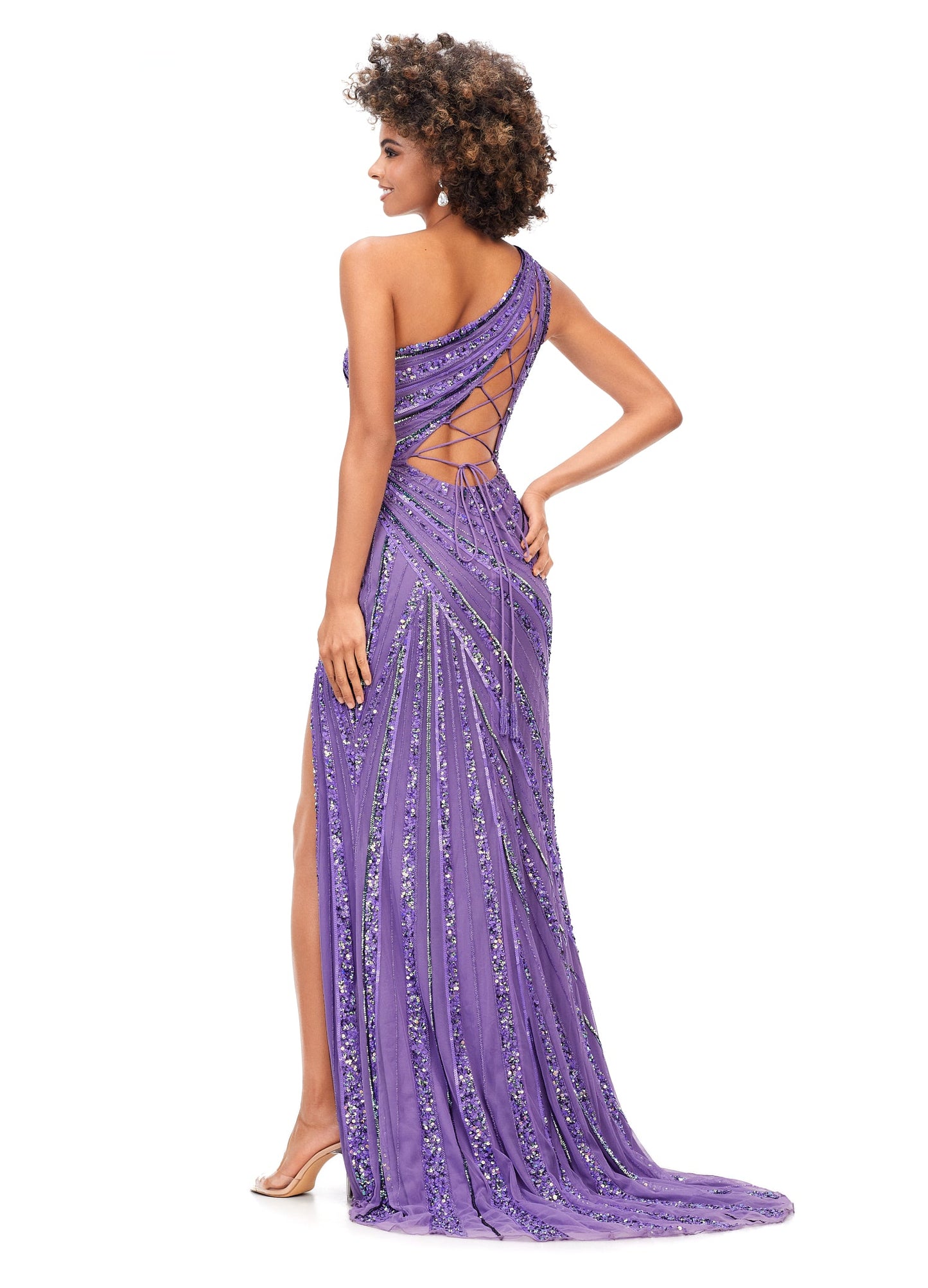 Ashley Lauren 11244 Long Sequin One Shoulder Prom Dress Formal Slit Gown Corset  This one shoulder gown features an intricate bead pattern that will accentuate your curves. The look is complete with a left leg slit and our signature asymmetrical lace up back. One Shoulder Lace Up Back Left Leg Slit Fully Hand Beaded Sizes: 00-18 Colors:  Purple, Neon Blue, AB/Ivory, Royal/Turquoise, Electric Coral, Jade, Neon Pink, Orchid
