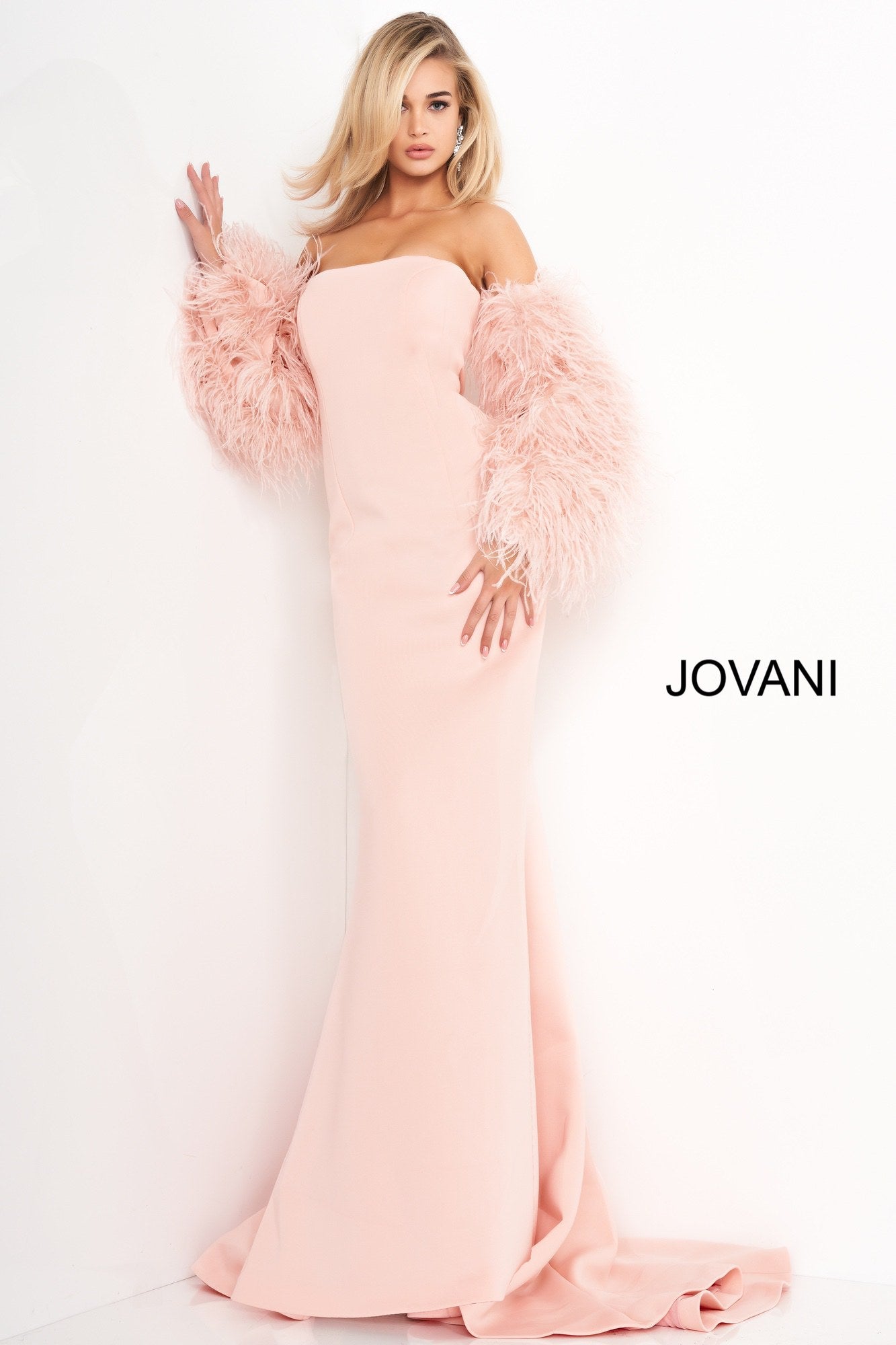 Jovani 1226 is a Long Fitted Mermaid Scuba Formal Evening Gown. This Straight neckline with Long Off the Shoulder Feather Sleeves. This Fit & Flare Wedding Dress Features a Lush Sweeping train. Great Red Carpet or formal event gown. Great for a wedding guest dress or mother of the bride gown. Stretch scuba fabric, form fitting silhouette, floor length with train, strapless bodice, straight neckline, ostrich feather sleeves. Available Sizes: 00-24  Available Colors: black, blush, white, white/black