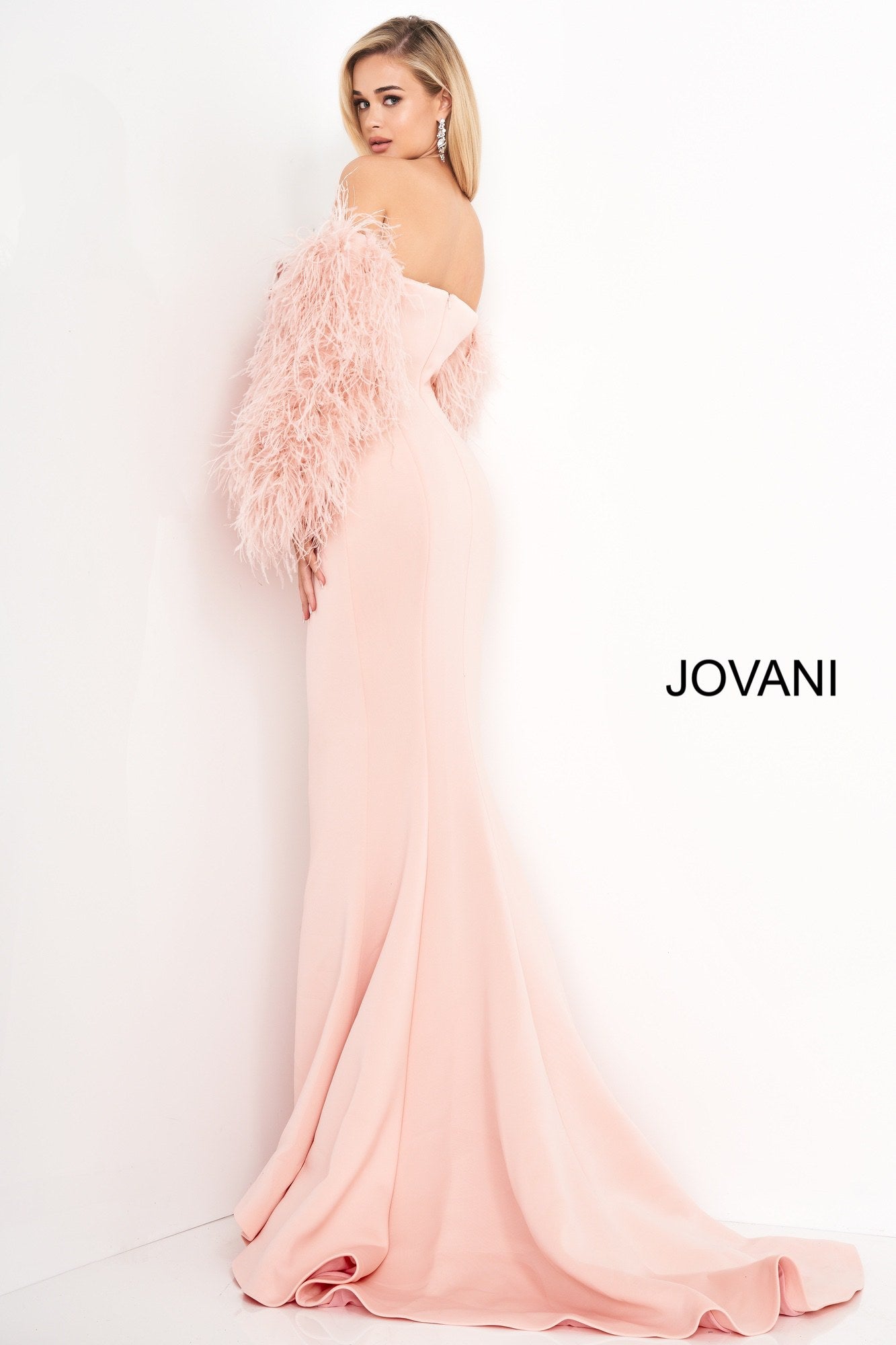 Jovani 1226 is a Long Fitted Mermaid Scuba Formal Evening Gown. This Straight neckline with Long Off the Shoulder Feather Sleeves. This Fit & Flare Wedding Dress Features a Lush Sweeping train. Great Red Carpet or formal event gown. Great for a wedding guest dress or mother of the bride gown. Stretch scuba fabric, form fitting silhouette, floor length with train, strapless bodice, straight neckline, ostrich feather sleeves.  Available Sizes: 00-24  Available Colors: black, blush, white, white/black