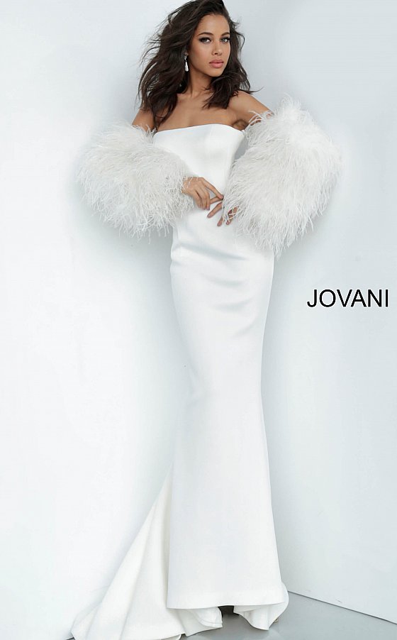 Jovani 1226 is a Long Fitted Mermaid Scuba Formal Evening Gown. This Straight neckline with Long Off the Shoulder Feather Sleeves. This Fit & Flare Wedding Dress Features a Lush Sweeping train. Great Red Carpet or formal event gown. Great for a wedding guest dress or mother of the bride gown. Stretch scuba fabric, form fitting silhouette, floor length with train, strapless bodice, straight neckline, ostrich feather sleeves. Available Sizes: 00-24  Available Colors: black, blush, white, white/black