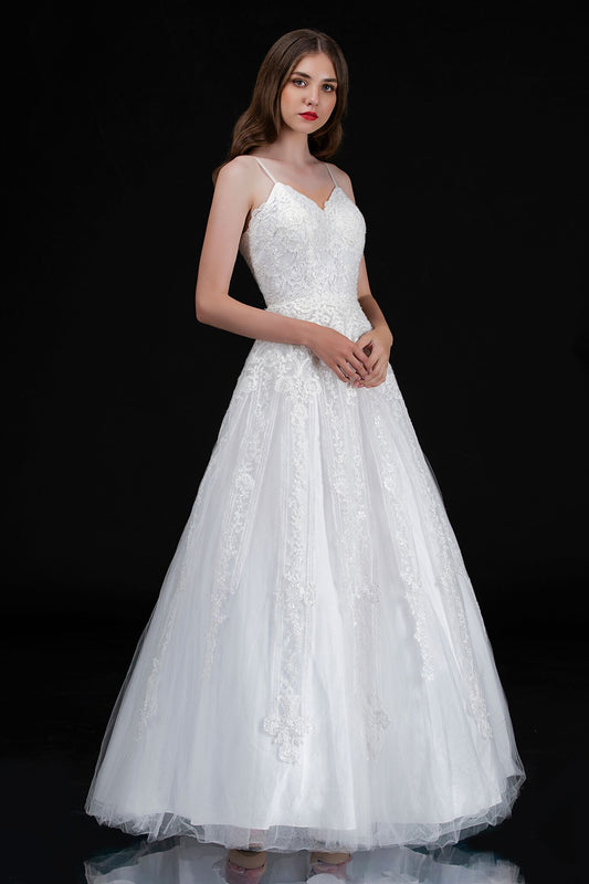 Nina Canacci 1508 is a long Lace Embellished Ivory wedding Dress. Featuring a scallop edge lace fitted bodice with adjustable spaghetti straps. Cascading floral embroidered lace flowing into the full a line ballgown skirt. Great Plus Size Bridal & Destination wedding dress. Sequin Embellished A Line Ballgown.   Available Sizes: 8  Available Colors: Diamond White