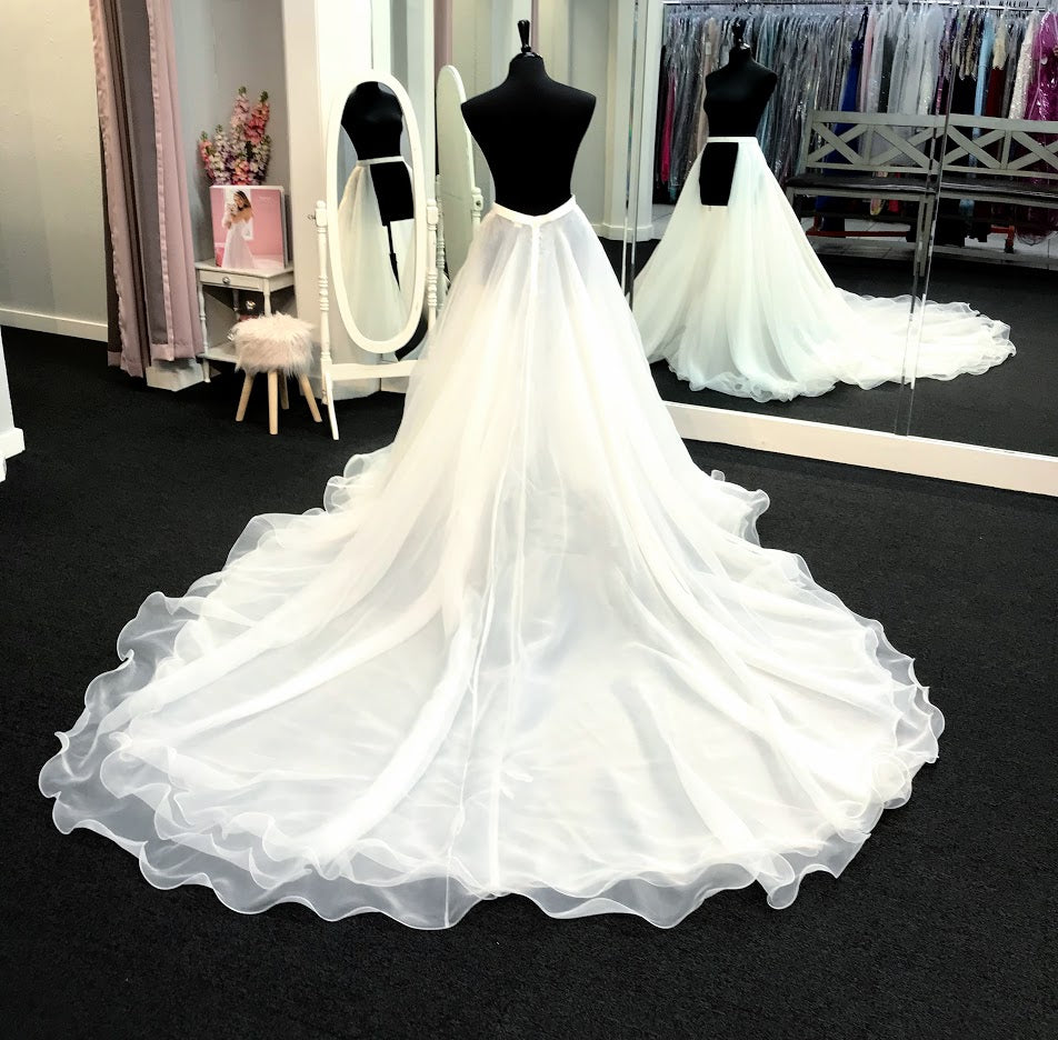 Ashley Lauren 1739 is a Long cathedral length organza multi layered overskirt with a ruffle hem. This Pageant & Bridal Over skirt is a Truly stunning addition to any gown!