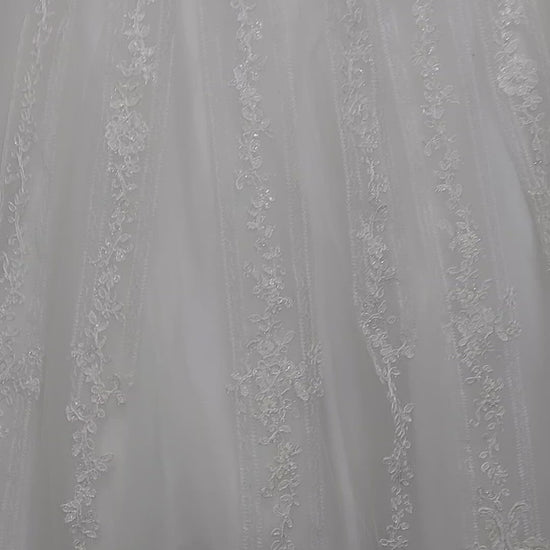 Nina Canacci 1508 is a long Lace Embellished Ivory wedding Dress. Featuring a scallop edge lace fitted bodice with adjustable spaghetti straps. Cascading floral embroidered lace flowing into the full a line ballgown skirt. Great Plus Size Bridal & Destination wedding dress. Sequin Embellished A Line Ballgown.   Available Sizes: 8  Available Colors: Diamond White
