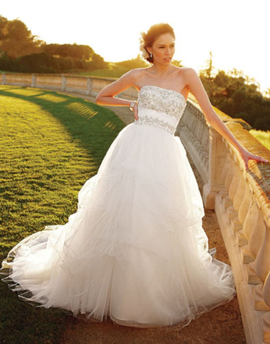 Casablanca Bridal 2052 Soft Tulle pick-ups over Silky Satin accented with heavily beaded bodice and a ruched Tulle waistband this wedding dress is over the top romantic.   Color:  Ivory/Ivory/Silver  Fabric: Tulle over Silky Satin with Beaded and Embroidered bodice.  This is a size 6 in Ivory & Silver