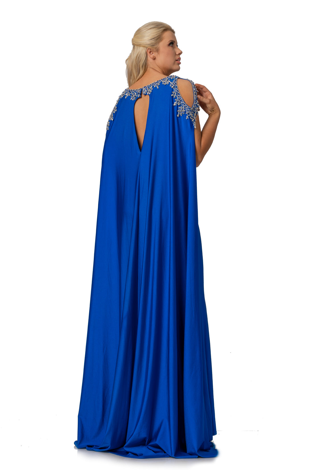 Johnathan Kayne 2075 is a Cape Prom Dress, Pageant Gown & Formal Evening Wear. This 4 way stretch Lycra gown features an Embellished illusion plunging high neckline. Embellished Over Cape Features Shoulder cutouts with a keyhole cutout in the back. skirt features a slit.