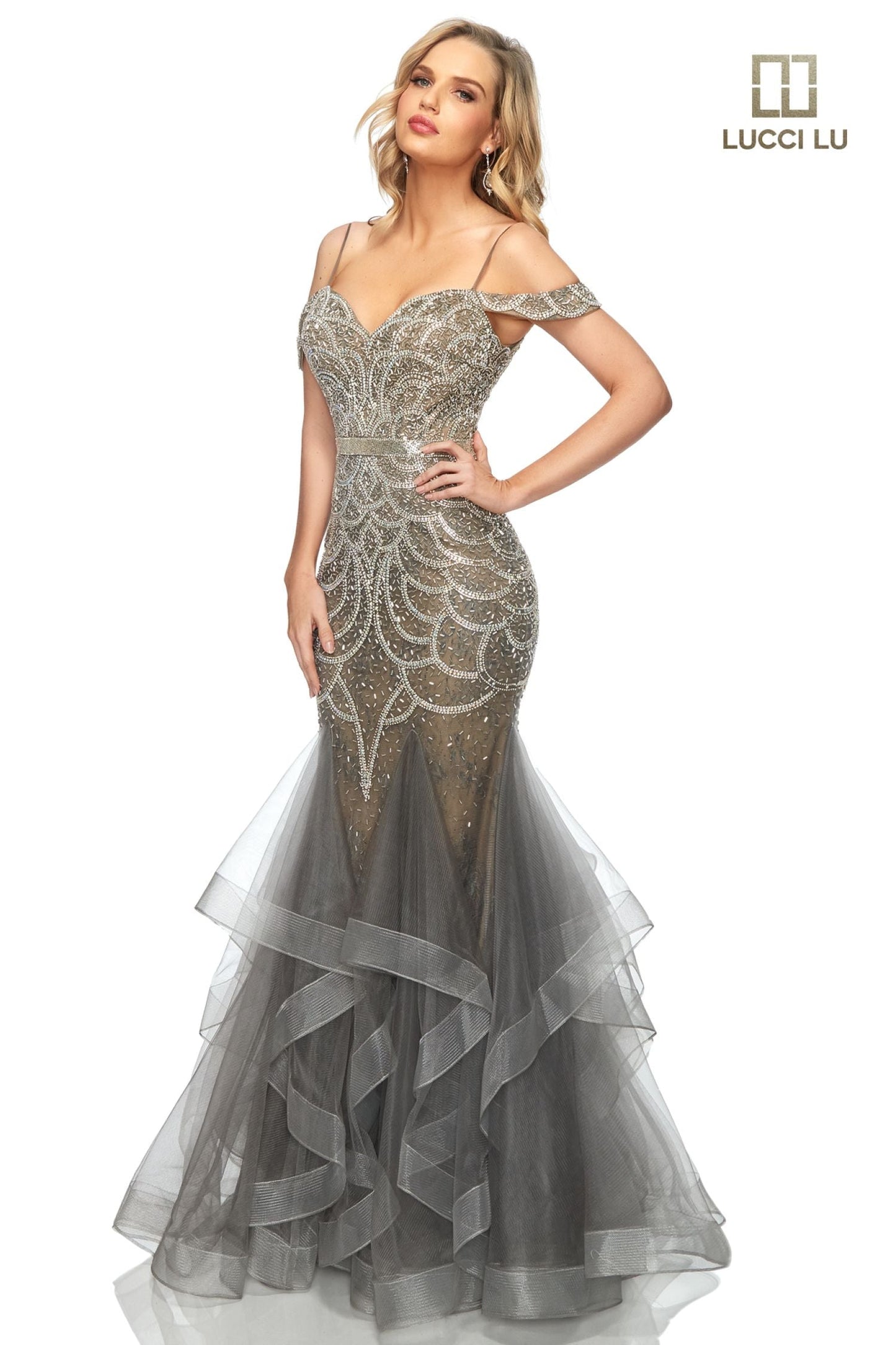 This classic Lucci Lu prom gown encapsulates sophistication and elegance with its beaded sequin-encrusted mermaid silhouette and cascading multi-layered ruffle skirt. Offering a secure fit with a secure off-the-shoulder neckline, 2147 is the perfect choice for luxurious evening events. Liquid beaded waist v neckline  Sizes:  0-16  Colors: Champagne, Dusty Blue, Dusty Rose, Gunmetal, Platinum/Gunmetal, Rose Gold