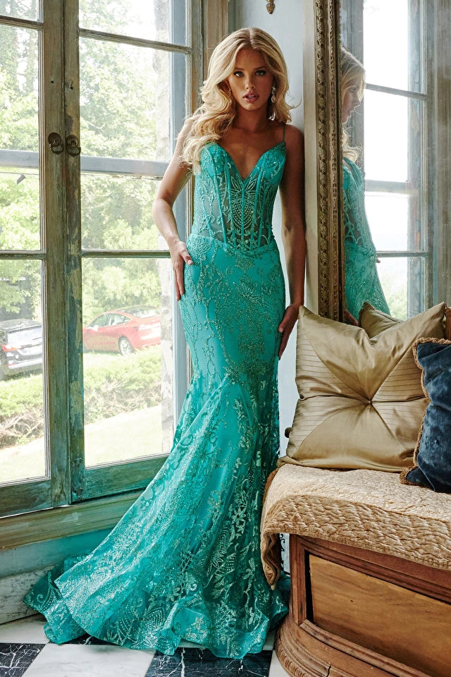 The Jovani 22388 Long Fitted Sheer Corset Mermaid Glitter Prom Dress is constructed with a fitted corset bodice, adorned with glittery accents and a mermaid silhouette. It is designed with a V-neckline, sheer fabric overlay and a long, ruched skirt. Perfect for special occasions, this formal gown will have you looking and feeling your best.  Size: 14  Color: Aqua