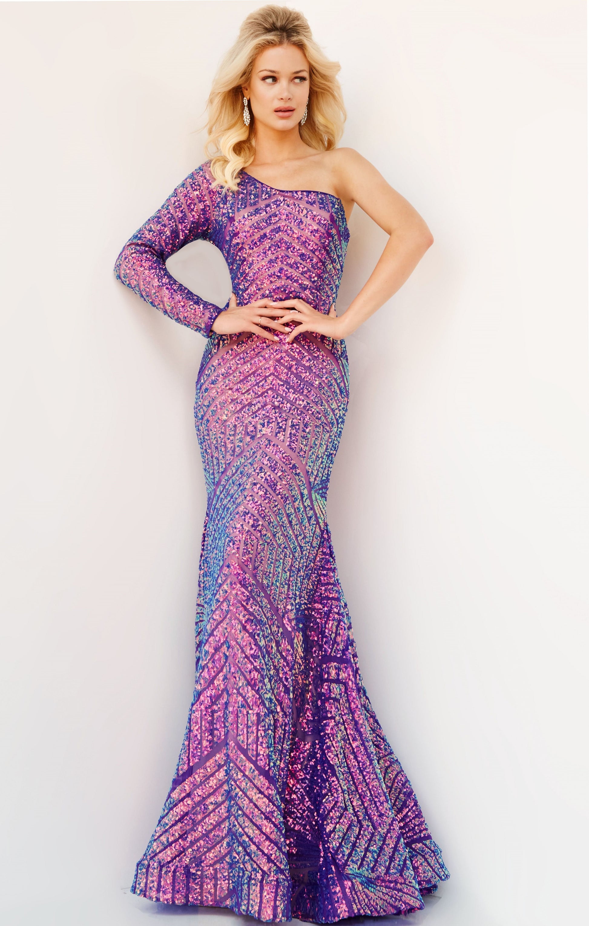 Jovani 24098 One Shoulder Long Sleeve Fitted Sequin Mermaid Prom Dress Pageant Gown Jovani 24098 is the perfect choice for a special occasion. It features a one-shoulder neckline, long sleeves, and a mermaid silhouette adorned with fantasy sequins. This fitted gown is designed to flatter, making you look and feel amazing.  Sizes: 00-24  Colors: EMERALD, IREDENSCNT BLUE, IRIDESCENT VIOLET, NEON HOTPINK, PEACOCK