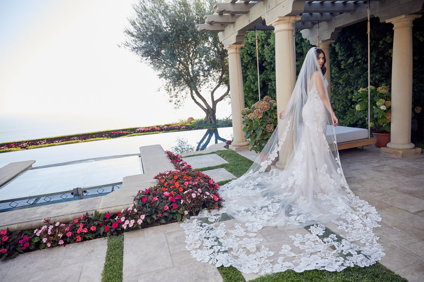 Style 2447 is designed for the Casablanca bride looking to stand out from the crowd. Romantic and sexy, this fit and flare wedding dress flaunts on-trend large scale floral lace for a look that won’t soon be forgotten. Tulle underneath adds a touch of softness while perfecting satin lines the inside for the most comfortable wear. Subtle beading punctuates the gorgeous floral lace, creating the perfect, ever-so-subtle glimmer. A 92 inch tulle train makes a statement, especially when paired with the jaw-dropp