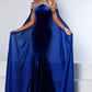 Johnathan Kayne 2535 Long Fitted Velvet Pageant Dress Cape Sheer Crystal Prom Gown A true showstopper! This velvet gown with high neck mesh bodice and sewn in charmeuse skirt will flow across your next pageant stage.  Colors: Emerald, Royal, Black  Sizes: 00, 0, 2, 4, 6, 8, 10, 12, 14, 16, 18  Fabric Stretch Velvet, Stretch Lining