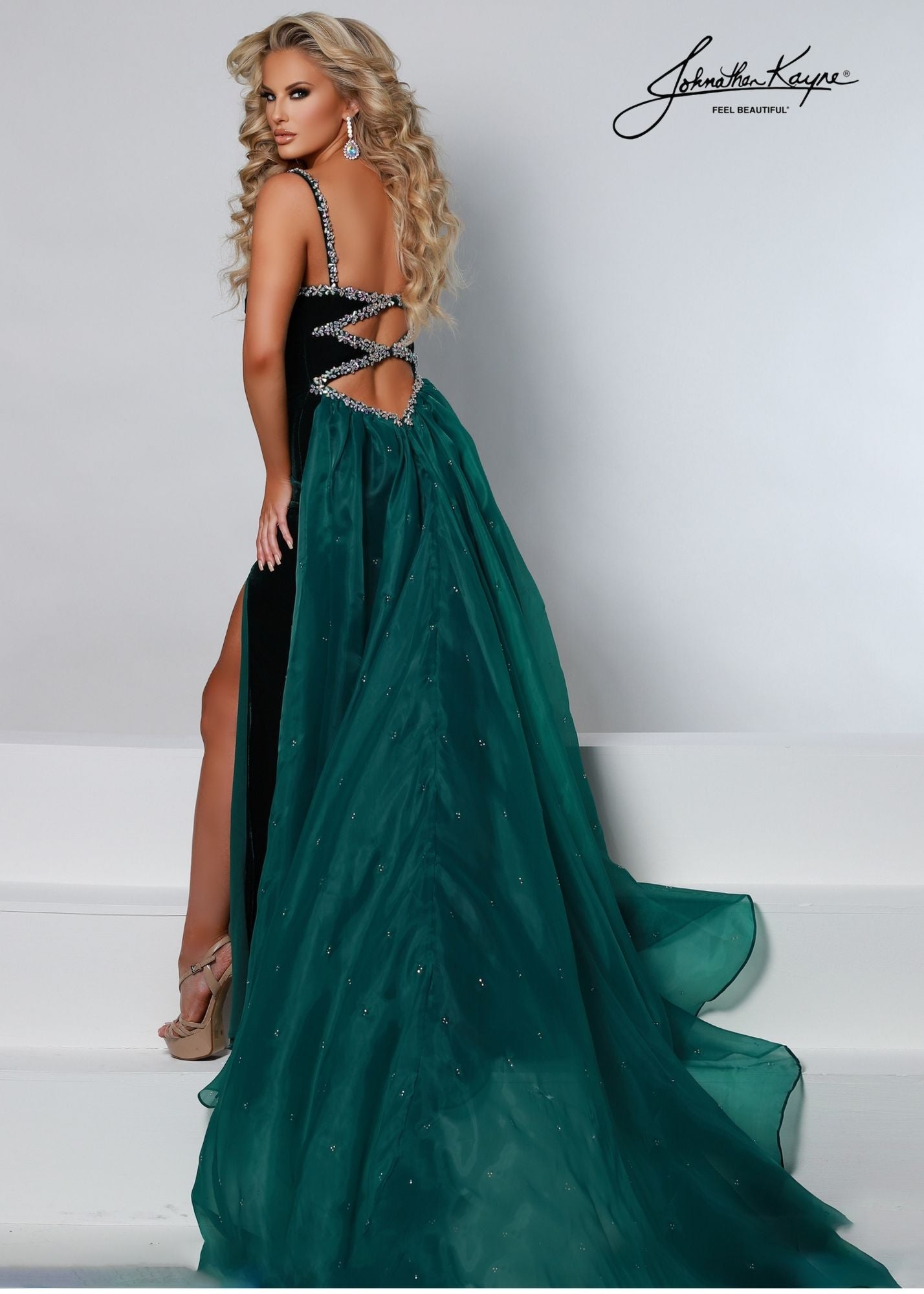 Johnathan Kayne 2549 Long V Neck Prom Dress Pageant Gown Crystal Overskirt Backless Showstopper! The plunging neckline is trimmed with hand beading as well as the cut out back bodice. The organza overskirt adds an elegant finish.  Color Emerald, Royal  Size 00, 0, 2, 4, 6, 8, 10, 12, 14, 16  Fabric Stretch Velvet, Mesh, Organza, Stretch Lining