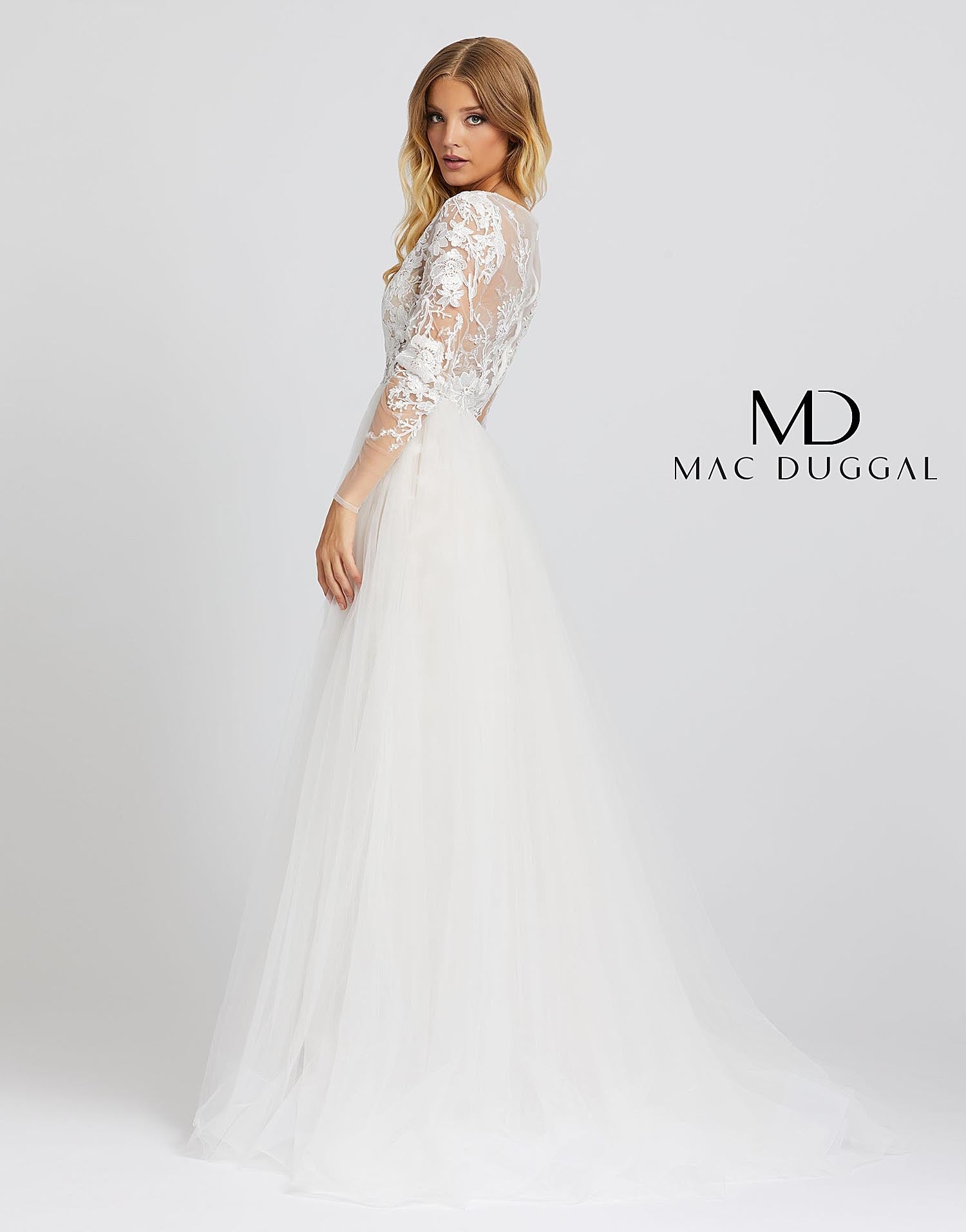 Mac Duggal 26322M - 26322 Love this dress so much you’ll want to re-wear it for your wedding! Style 26322M is an ivory nude ball gown with sheer long sleeves, a v-neckline, and overskirt. This incredible gown has embroidery detailing from head to toe. 