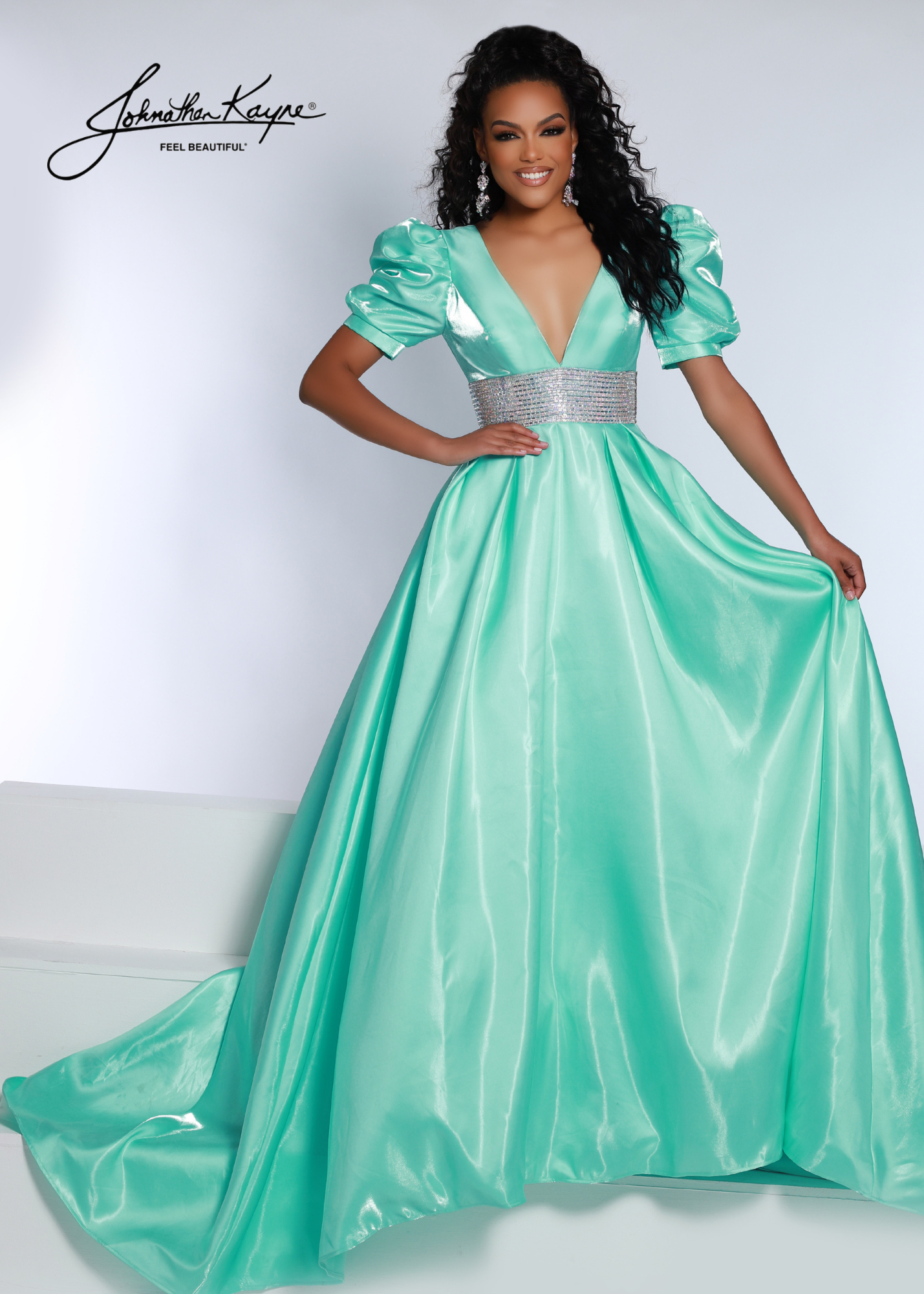 Johnathan Kayne 2692 Shimmer Satin A Line Puff Sleeve Prom Dress Crystal Waist Pageant Gown One of our best sellers from the fall, but LONG! This shimmer satin gown has puff sleeves and a V-neck bodice with a thick crystal trim waist band. Did we mention it has pockets?  Sizes: 00-24  Colors: Aqua, Cherry, Black, White