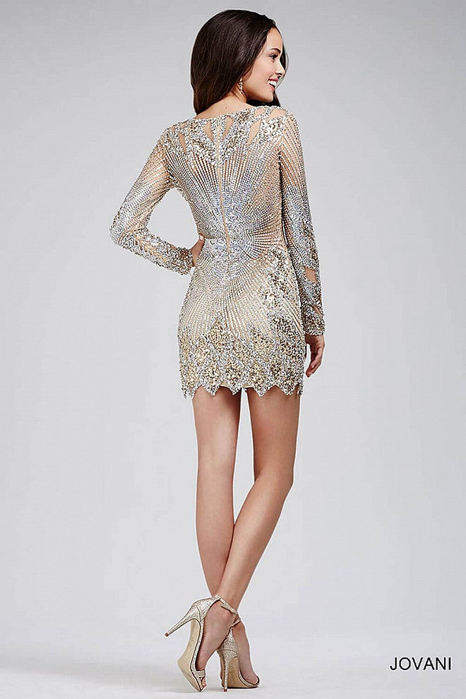 Jovani 27205 Short fitted nude cocktail dress features long sleeves, cutouts on the shoulders, a deep V neckline, sequin embellishments. Great for Prom, Pageant or a Night out on the town.