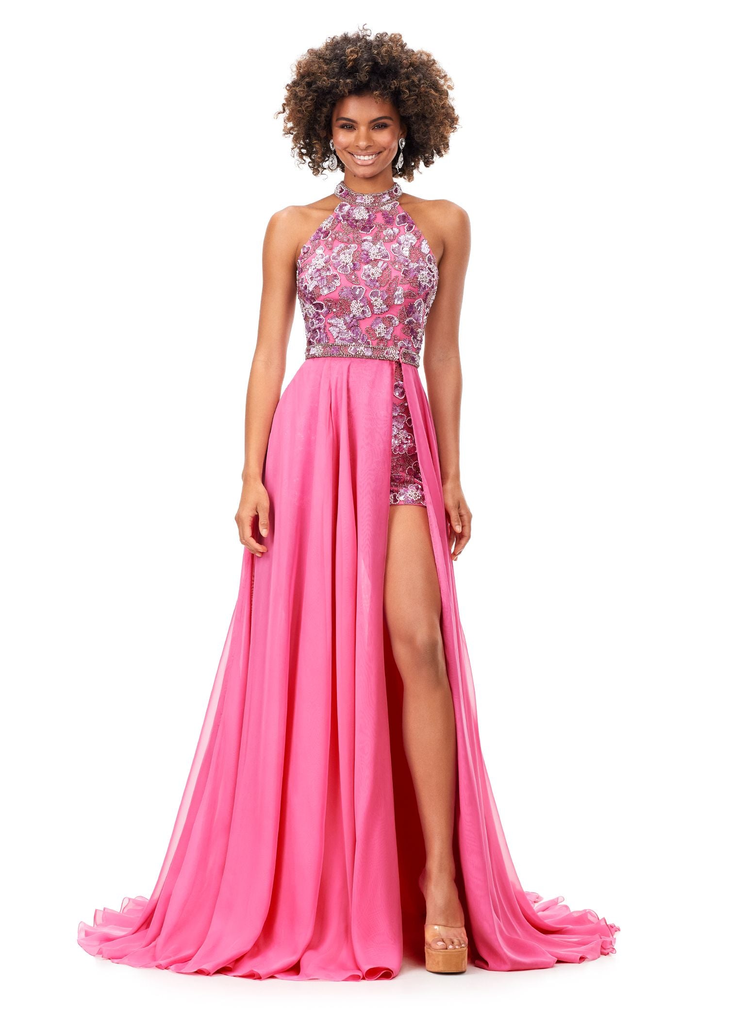 Ashley Lauren 11354 This halter romper features an intricately beaded floral motif throughout. The look is complete with a chiffon detachable skirt and beaded belt. Halter Neckline Romper Detachable Chiffon Overskirt Fully Hand Beaded COLORS: Black, Red, Ivory, Royal, Orchid/Pink