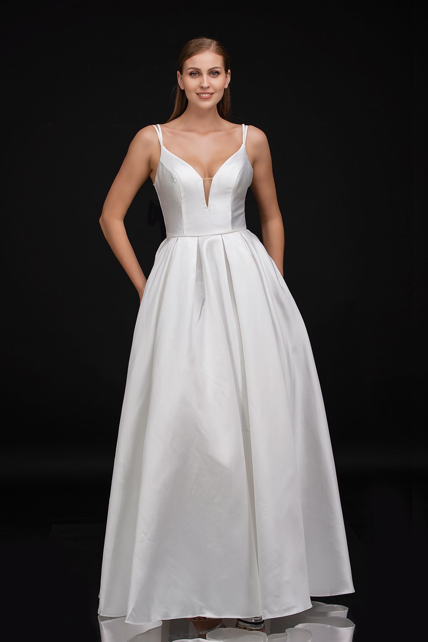Nina Canacci B1900 plunging V neckline with mesh panel satin prom dress evening gown with double straps that lead to a bow in the lower back at the waistline and flows into a satin A line skirt   Color Diamond White  Sizes 0, 2, 4, 6, 8, 10, 12, 14, 16, 18, 20, 22, 24 