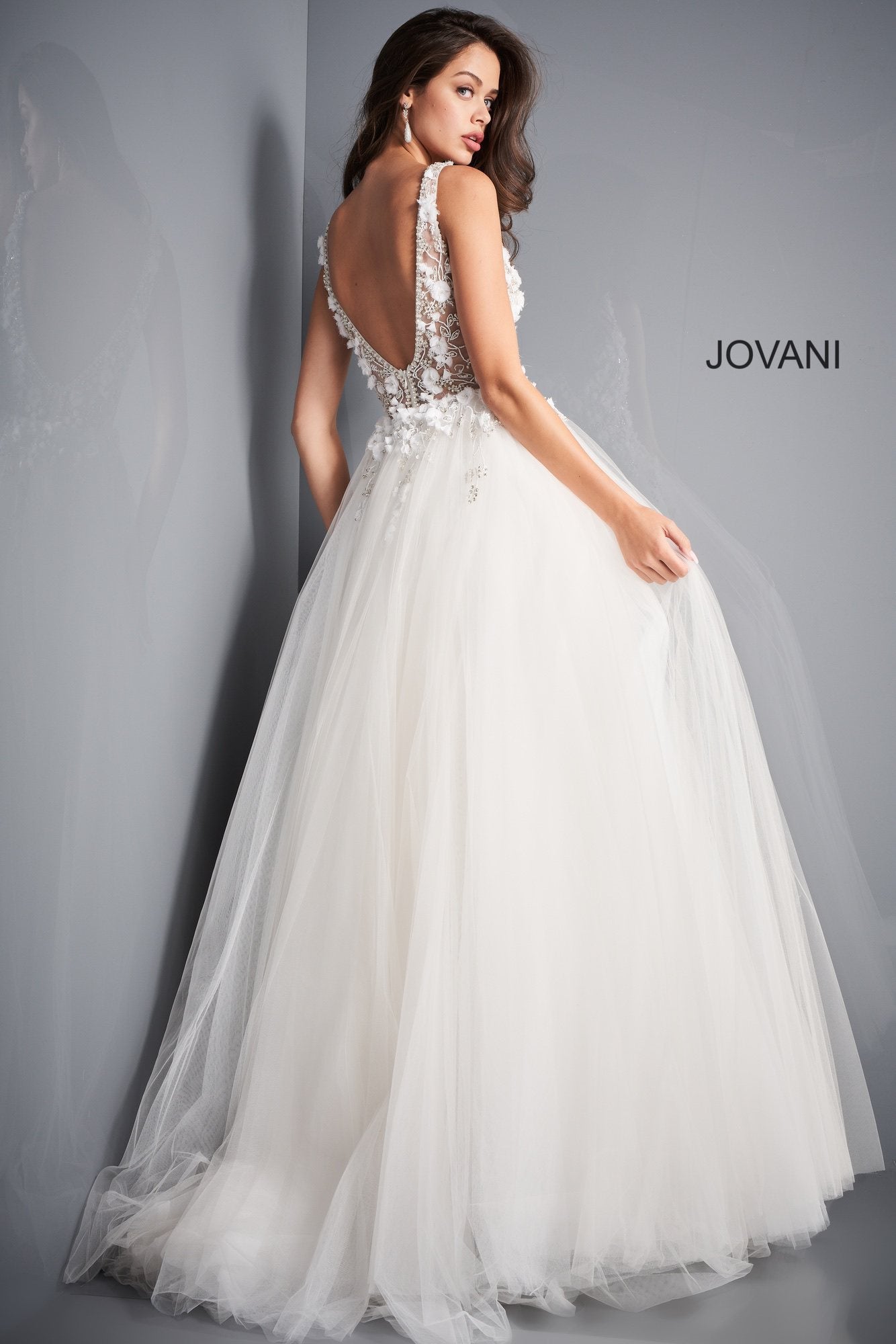 Jovani 3110 is a stunning tulle ball gown Prom Dress. Embellished 3D Floral Appliques on Sheer Illusion Bodice. Deep V Neckline & Back.  This gown would be a Perfect Sexy Wedding Dress In Ivory!  Available Sizes: 00, 0, 2, 4, 6, 8, 10, 12, 14, 16, 18, 20, 22, 24  Available Colors: blue, ivory, red
