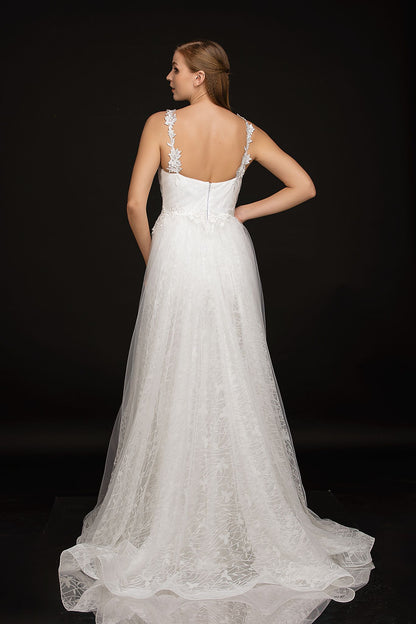 Nina Cancci 3159 is a long Lace Fitted Ivory Floral Lace Applique strap wedding dress. cracked Ice Over skirt and sweeping train. Stunning Destination Bridal Gown. Great for Plus Size! Glitter sweetheart neckline. Accented scroll pattern on the flowing overskirt. shimmering bridal gown or unique wedding dress. Sheer lace embellished straps.   Available Sizes: 8  Available Colors: Ivory/Nude