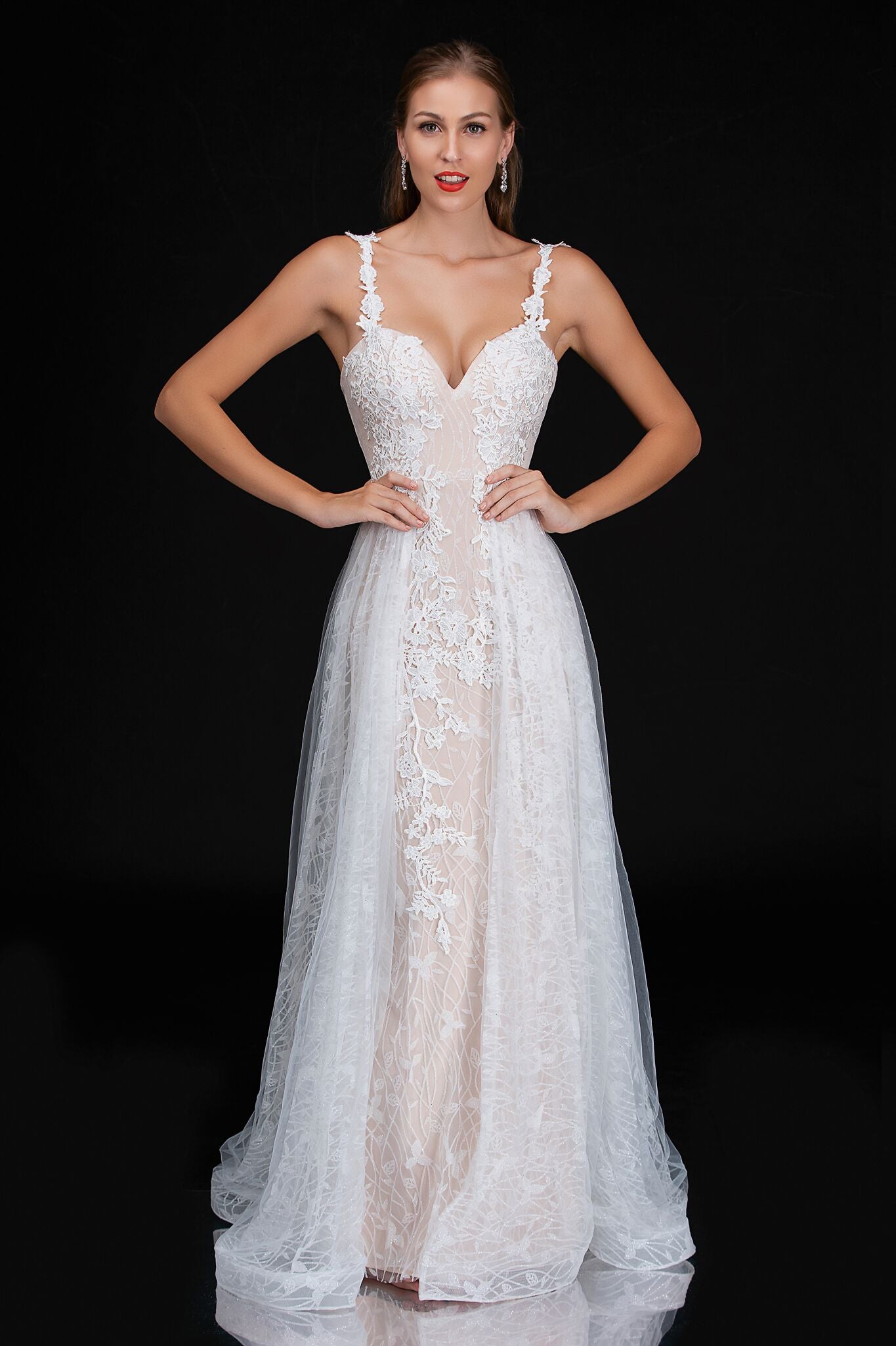 Nina Cancci 3159 is a long Lace Fitted Ivory Floral Lace Applique strap wedding dress. cracked Ice Over skirt and sweeping train. Stunning Destination Bridal Gown. Great for Plus Size! Glitter sweetheart neckline. Accented scroll pattern on the flowing overskirt. shimmering bridal gown or unique wedding dress. Sheer lace embellished straps.   Available Sizes: 8  Available Colors: Ivory/Nude