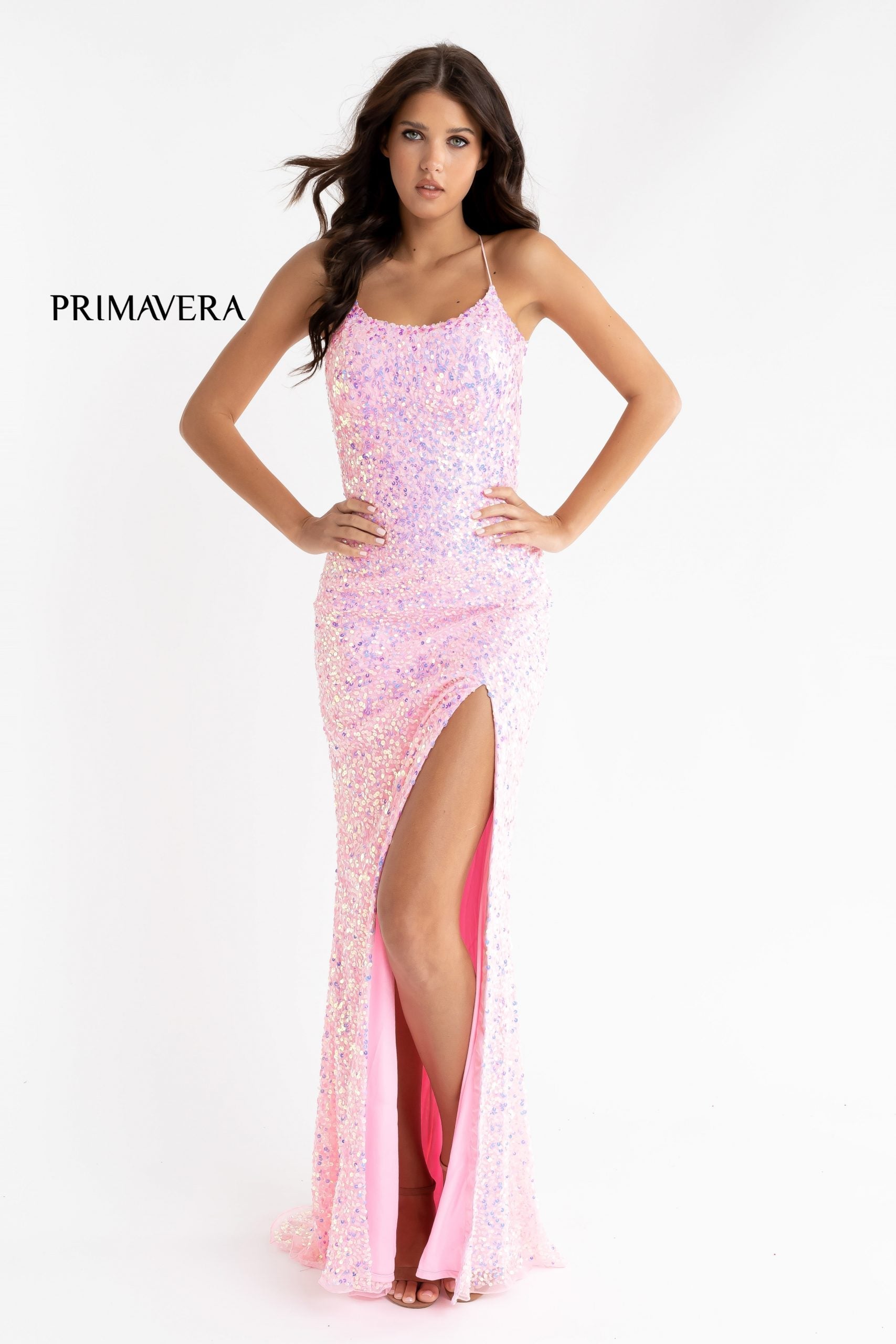 Primavera Couture 3290 This prom dress adds a pop to the multi sequins dress.  With a scoop neckline and spaghetti straps that cross and tie in the back.  This long evening dress has a side slit. 
