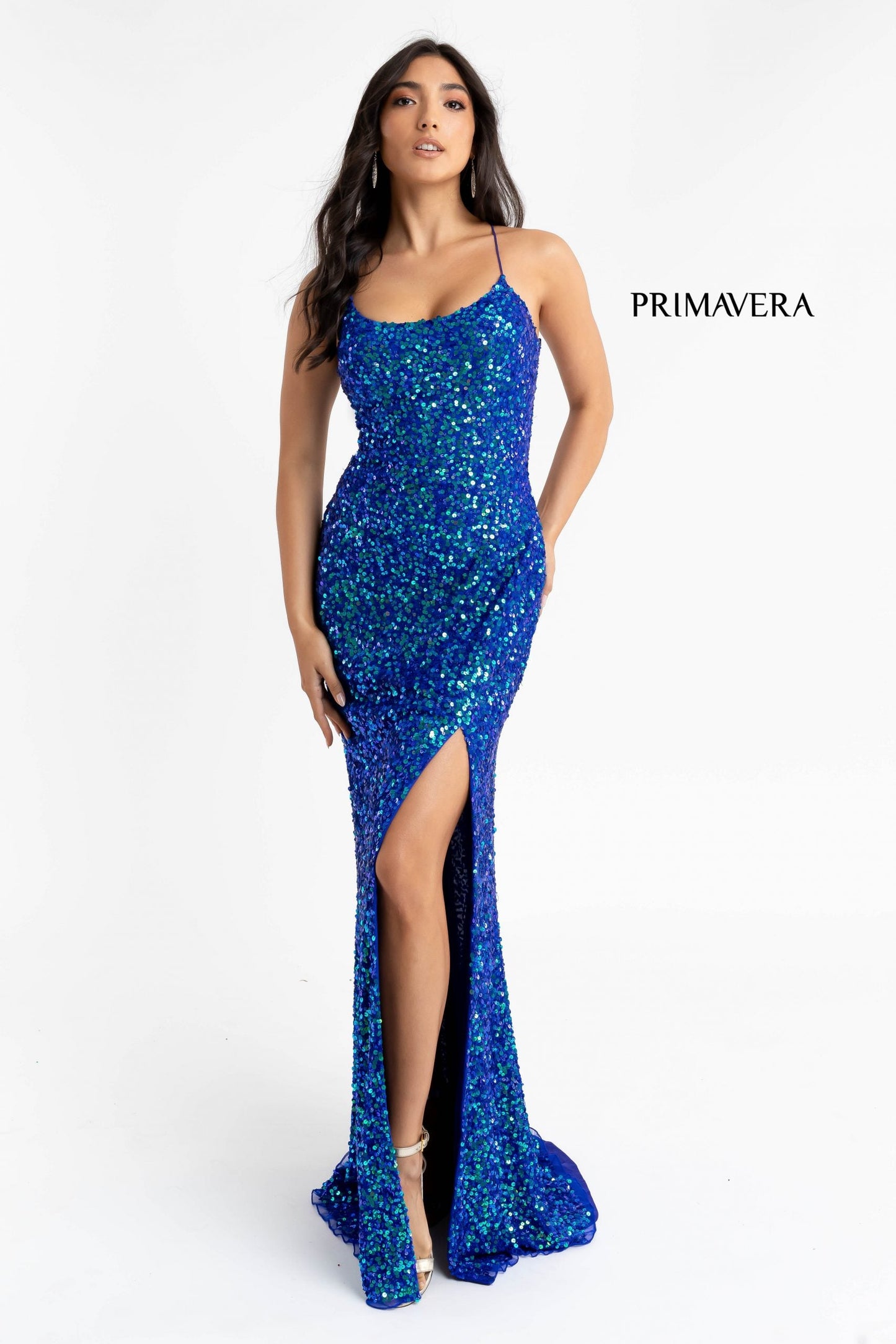 Primavera Couture 3290 This prom dress adds a pop to the multi sequins dress.  With a scoop neckline and spaghetti straps that cross and tie in the back.  This long evening dress has a side slit. 