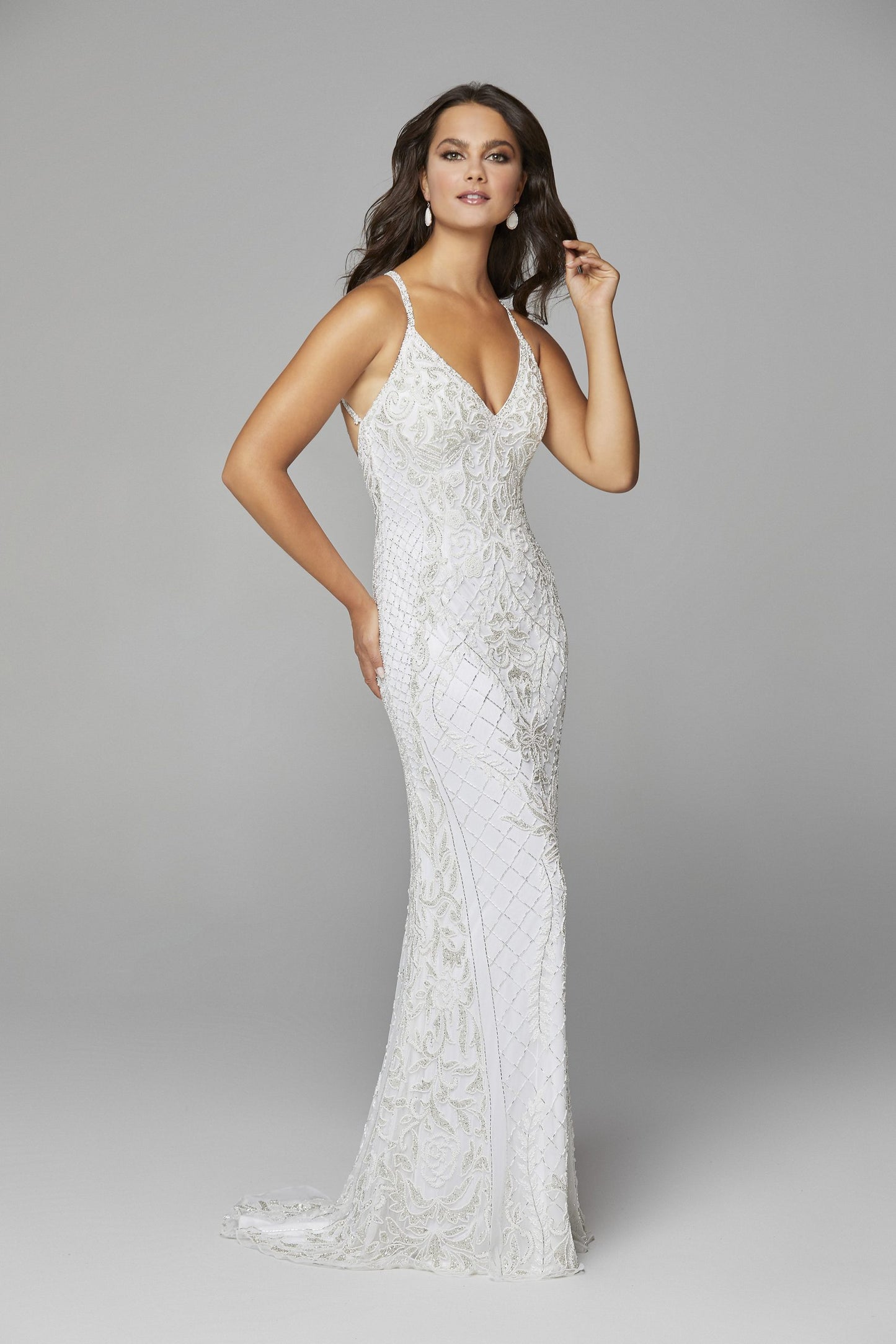 Primavera Couture 3428 is a beaded Prom Dress, Pageant Gown, Wedding Dress & Formal Evening Wear gown. This Gown Features a v neckline with spaghetti straps that criss cross in the open back full long sequin and bead skirt.   Available colors:  Ivory  Available sizes:  8, 12