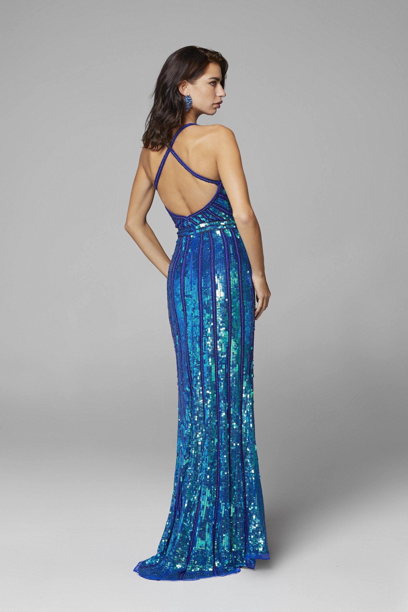 Primavera Couture 3441 is a iridescent sequins long formal Prom Dress, Pageant Gown, Wedding Dress & Formal Evening Wear gown. Featuring a v neckline with Iridescent Multi sequins and Hand Embellishments. This evening gown is perfect for any formal event! Slit in skirt. Available colors:  Ivory, Royal Blue, Teal, Peacock, Pink, Raspberry Available sizes:  00,0,2,4,6,8,10,12,14,16,18