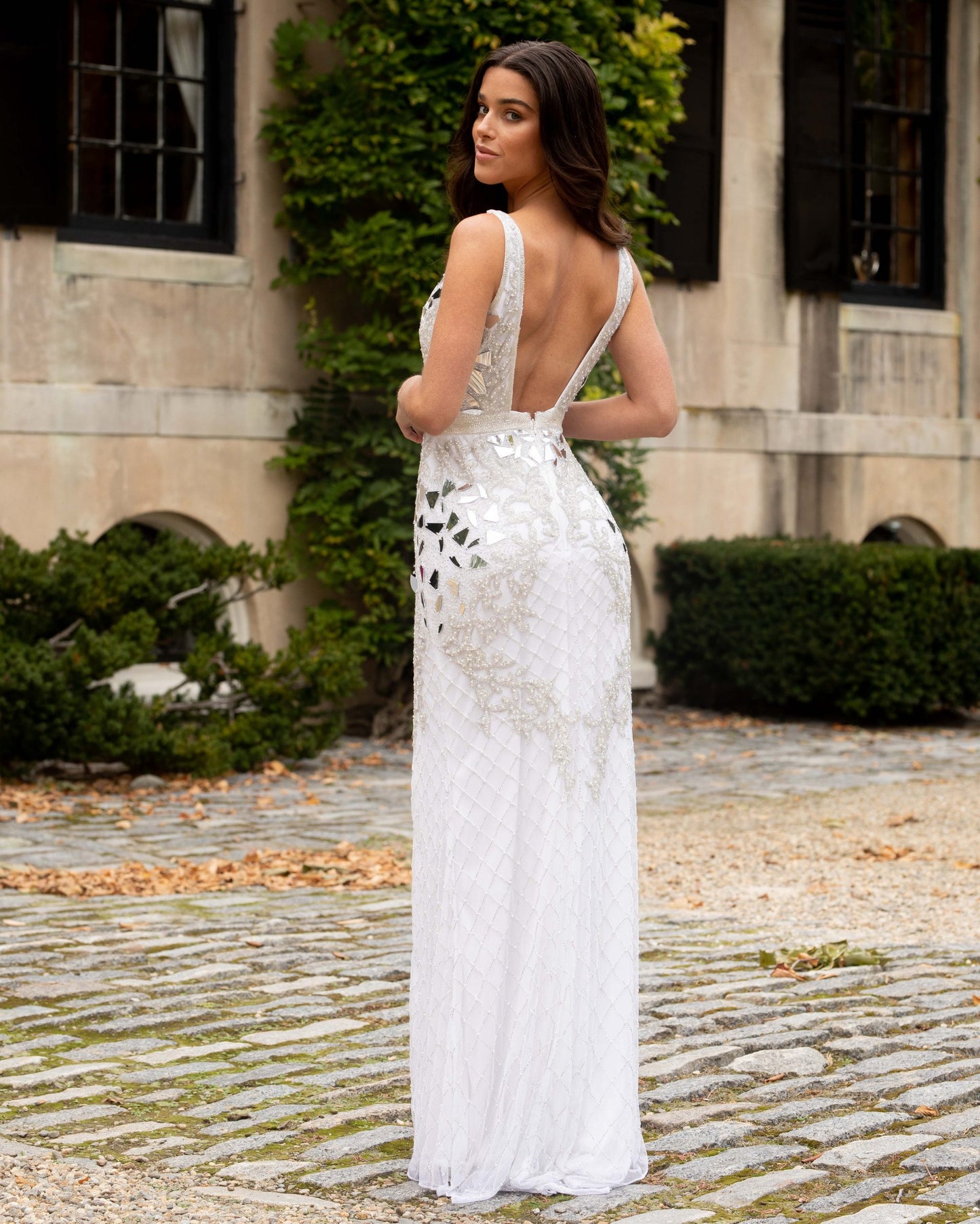 Primavera Couture 3640 is a stunning Long Fitted Formal Evening Gown. Great for Prom, Pageants & More! V Neckline with an open back. Fully beaded & Embellished with Cut Glass Accents along the fitted bust. Floral scroll details with beading & Sequins. Slit in skirt. Great wedding reception dress in Ivory!  Available Sizes: 00,0,2,4,6,8,10,12,14,16,18  Available Colors: Ivory, Gold, Lilac, Platinum, Raspberry
