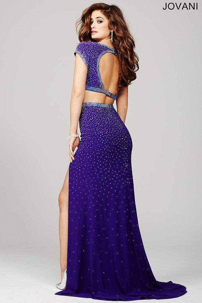 Jovani JVN 36743 JVN36743 Beautiful two-piece prom gown features an open back and sexy slit with cap sleeve top and hot stones set throughout for that extra bling.  two piece prom dress cap sleeve slit backless cut out.  Size 6 - Purple.
