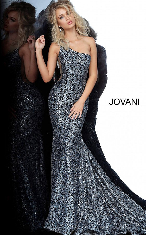 Jovani 3927 is a one shoulder Prom Dress, Pageant Gown & Formal Evening Wear gown. This Stunning Long Mermaid Fit & Flare Prom Dress features a 2 tone lace with embellishments throughout. Sheer mesh side panels. and a lush flared trumpet skirt with a train.
