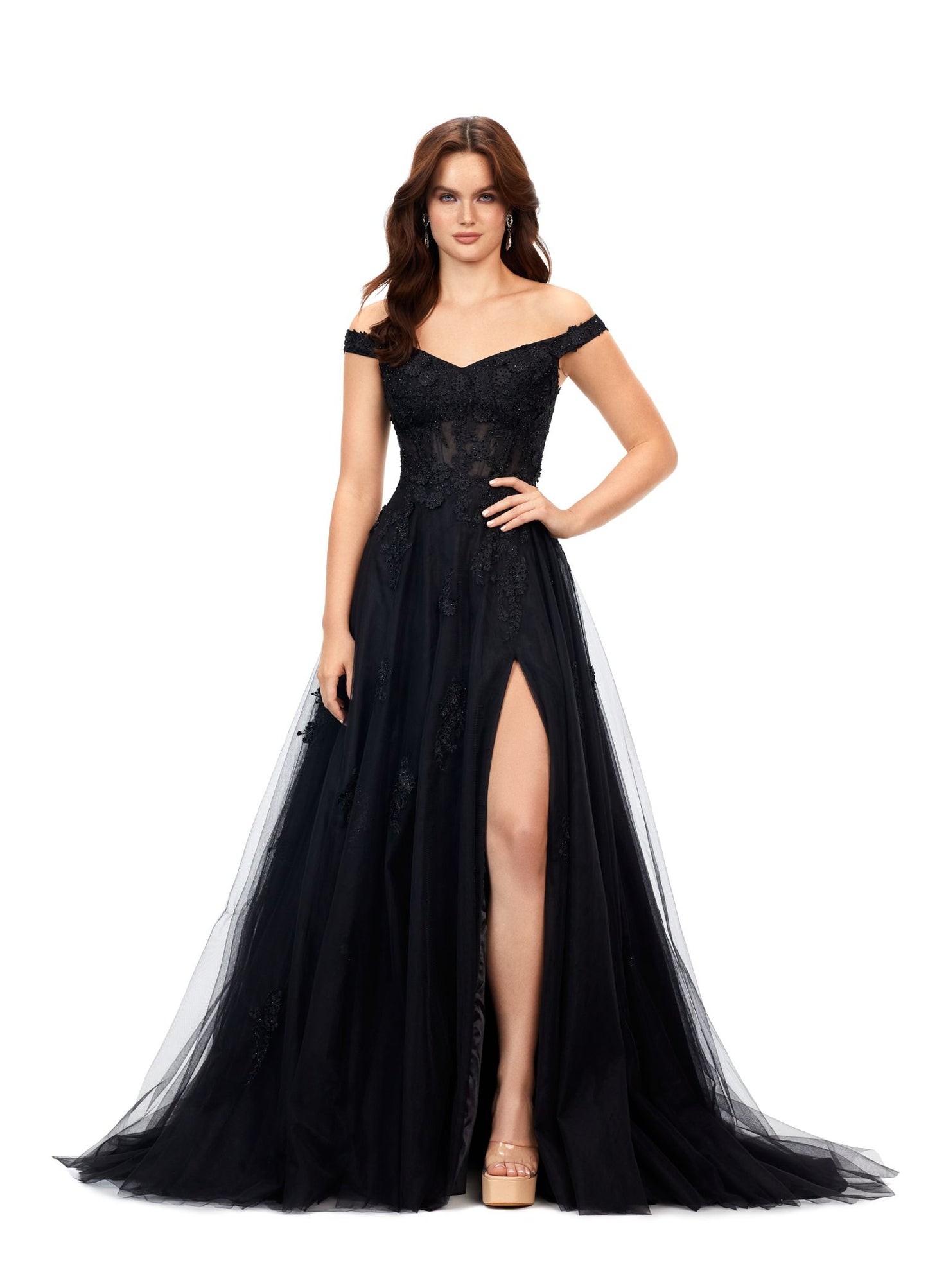 Ashley Lauren 11376 This off the shoulder fairytail dream gown features an illusion corset and 3-dimensional lace flower appliques throughout layers of tulle. The look is complete with a left leg slit. Off Shoulder Neckline Illusion Bodice 3-Dimensional Lace Flower Appliques Tulle Black, Pink