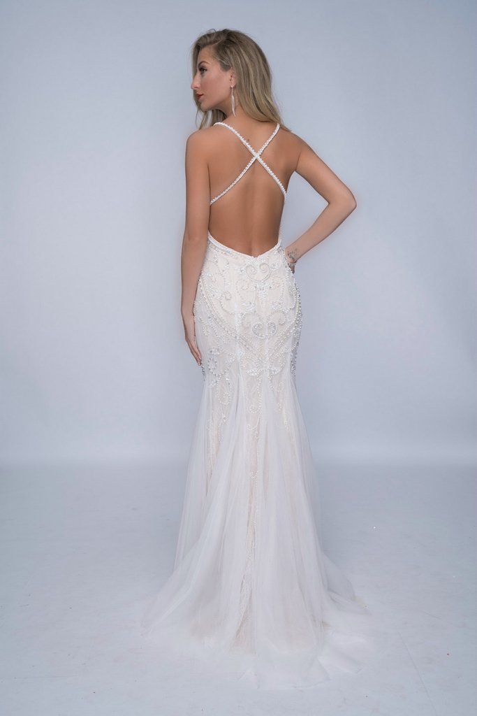 Nina Canacci 4181 is a fully embellished & Beaded long Ivory & Nude Formal Evening Gown, Wedding Dress, Prom Dress & Bridal. This Backless gown features fully beaded straps with a lace underlay bodice with crystal rhinestone embellishments and beading leading to a slight trumpet tulle mermaid skirt.  Available Sizes: 12  Available Colors: Ivory/Nude   